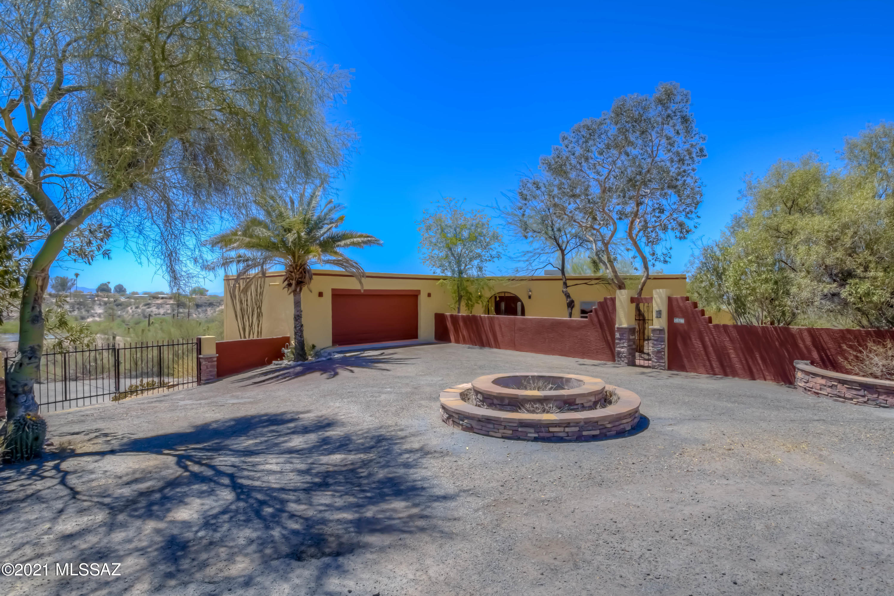 Your chance to own a true gem in the heart of NW Tucson! This nearly 4,000sqft home boasts spectacular city and mountain views and is located close to shopping, entertainment, and thoroughfares. Walk through the romantic courtyard and into the foyer with formal living area off to the right and kitchen to the left. The living area features a beautiful fireplace and opens to a room with wall-to-wall windows and amazing views of the Catalinas, Downtown Tucson, and A Mountain. Huge laundry room opens to a 2-car garage with plenty of storage. Downstairs has another large living area with Saltillo tile and a wood burning fireplace with double doors that reveal your own desert oasis complete with a sparkling pool, attached spa, and majestic mountain views! The extended covered carport includes 220V hookup for RV parking and plenty of onsite parking for parties or gatherings. Call for a showing today!