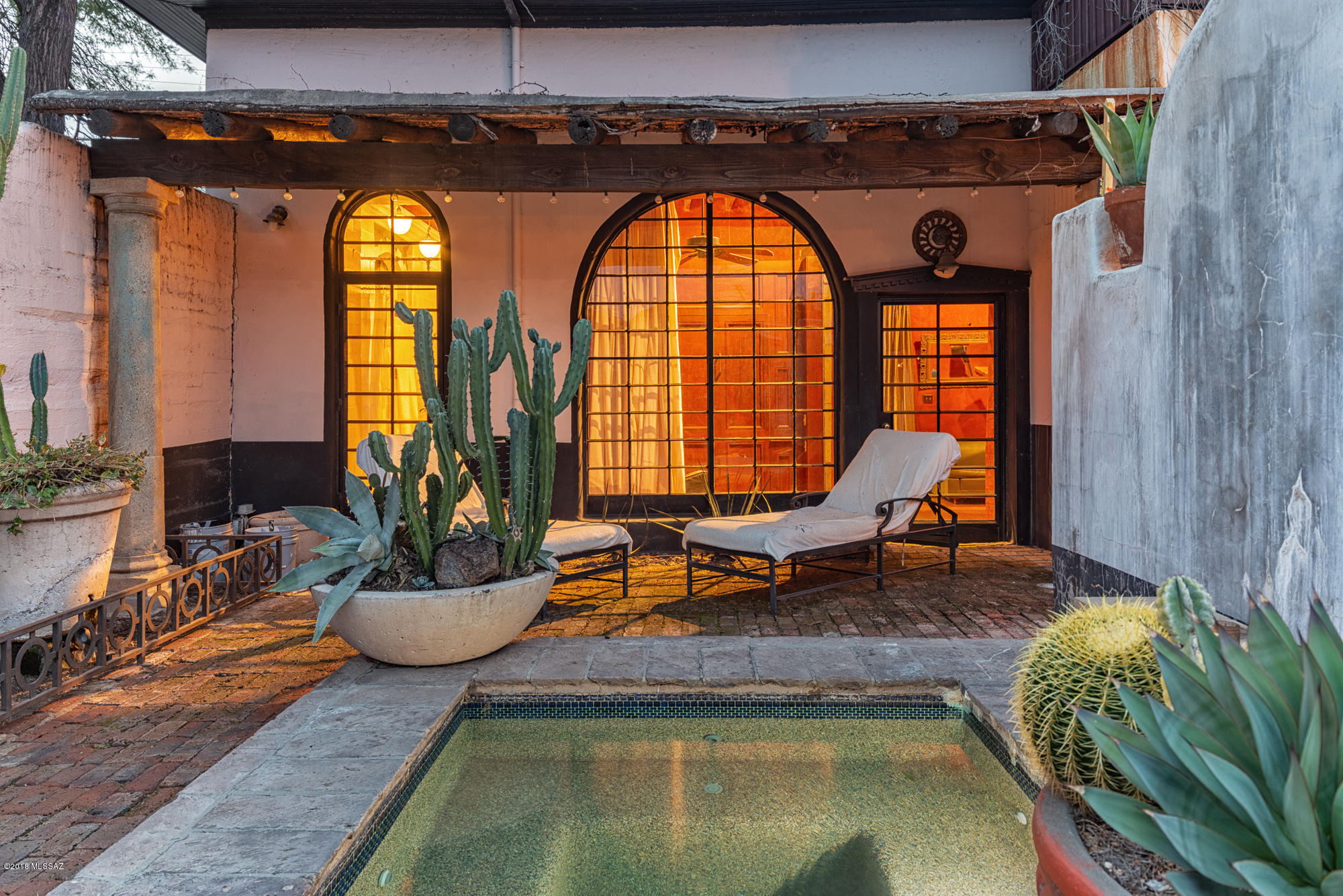 Seller will accept/counter $954,000-$989,000
Greatest historic house in Tucson. One-of-a-kind 16' beamed ceilings with Saguaro ribs. Brick floors. 1 bedroom has its own street entrance so it could be used as an office or guest quarters. Kitchen has stainless commercial appliances and custom sink, counters and cabinets that you will never see in another house. Separate formal dining room off the kitchen. Large, enchanting backyard with fountain(gas torches) and a pool that looks like it came from a hacienda in Mexico. 10' hand-carved doors in the living room, which also has windows that go from the floor to the ceiling. Master bedroom has its own fountain and open views to the backyard and fireplace. Master bath has details you'd find in a castle!  MAGICAL DETAILS will greet you in every r
