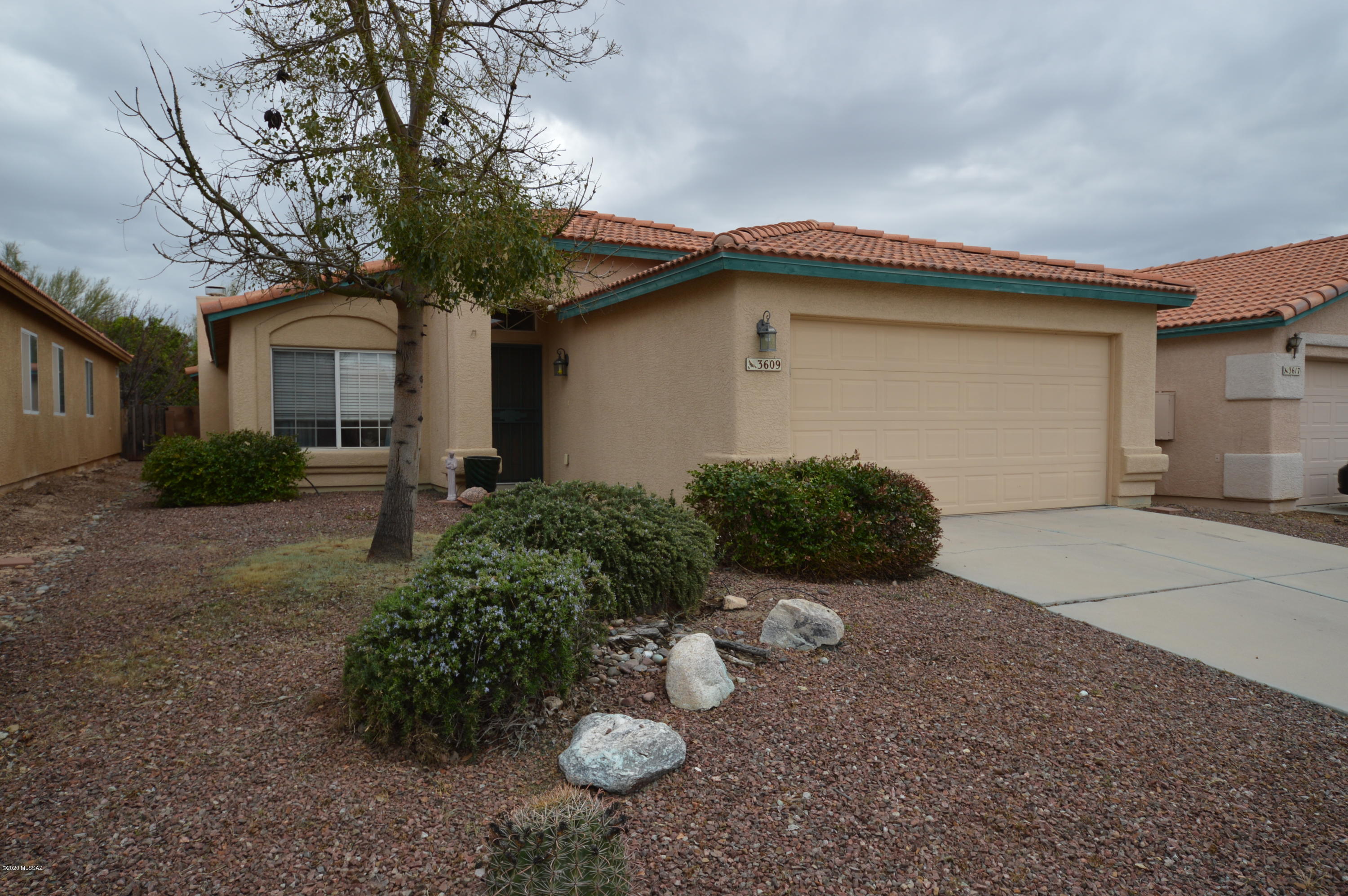 Exceptional 3/2 in Rancho Escondido.  Terrific Marana schools, quiet neighborhood.  Ceramic tile throughout. Gourmet kitchen with tile counters and breakfast bar. Large family room with fireplace. Luxurious master suite with walk in closet, garden tub and separate shower. Back yard has covered patio and separate gazebo for additional shaded entertaining space.  Community pool and park are right down the street.  This gem wont last long, so CALL TODAY!!