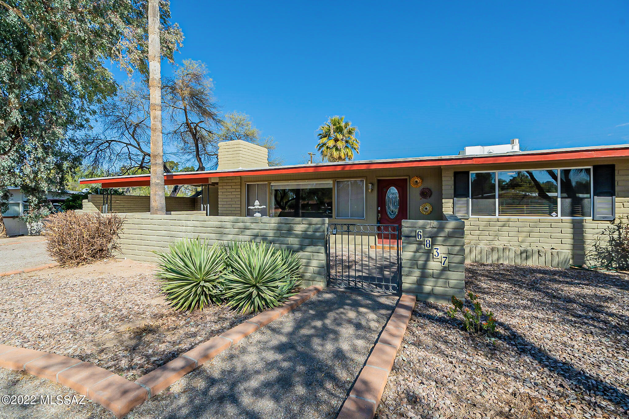 Home Sweet Home!!! Spacious mid-century updated home in the desirable & historic Indian Ridge community. Front Courtyard & fountain welcome you into this 4BR/2BA, 2009sf home. Featuring updated Kitchen , baths, neutral tile throughout, new interior paint, open/flexible floor plan, updated lighting, great storage, fireplace, 4th bedroom/den has it's own entrance & is perfect for a home office/guest suite & has walk-in cedar closet. Large covered back patio overlooks a large enclosed  rear yard. w/ Catalina Mtn. views. Large 2 car-carport w/ storage & access into home  RV's OK - No HOA. Large 318 sf storage room/work shop! Historic status = low taxes! Floor plan, historic info, in MLS.  SEE MORE... Indian Ridge Historical Designation was established in 2011.

There may be a 15-year property tax reduction available. The new owner needs to apply thru the State Historic Property Tax Reclassification at http://azstateparks.com/SHPO/propertytax.html
