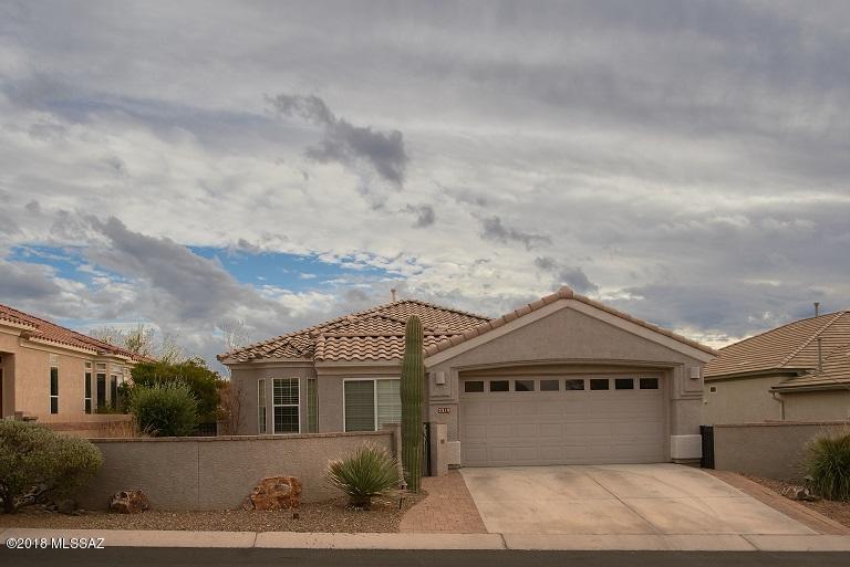Spacious open floor plan welcomes you to The Highlands @ Dove Mountain active adult community. Private courtyard w/gated entry provides excellent patio space and brings you to the ultimate wrought iron security door. Home offers 2 bedrooms w/ den that surround the open living space. Kitchen offers luxury appliances w/ sprawling island & granite counter tops that look onto living space. Living room is pre-wired w/ surround sound for optimal entertainment. Shutters on windows throughout add a nice touch for natural light. Back patio provides views of the SW mountains & sunsets. Large utiltiy room is equipped with cabinets for storage in addition to more storage space in the garage. Additional golf cart park space is great work space, storage or parking.