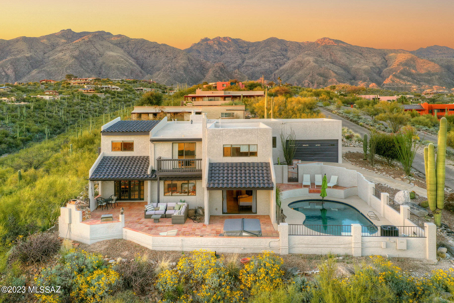 Enjoy incredible views from this beautifully appointed 5BR/4BA home nestled in the Catalina Foothills.  Rare opportunity to purchase the property ''turn-key'' for use as a personal residence or as a profitable investment property.   Enjoy the Tucson's lifestyle on the expansive back patio enjoying a casual BBQ, entertaining friends poolside, or relaxing by the outdoor FP.   The flexible floor plan affords space for everyone and includes a cozy living room w/FP and separate dining room joined by a private patio, an inviting family room for casual living and a huge game room. Spacious kitchen boasts resurfaced cabinets, a breakfast bar and adjacent breakfast room.   The main floor primary suite w/beehive FP is features an updated bathroom w/double vanities & large closet. Con't Upstairs are four large bedrooms, 2 full baths and loft.  Updates include new flooring, interior and exterior paint, updated baths, new light fixtures and fans, resurfaced pebble-dec pool and pool deck, pool pump and heater w/automation system, recoated roof, water heater and 3 new AC units.