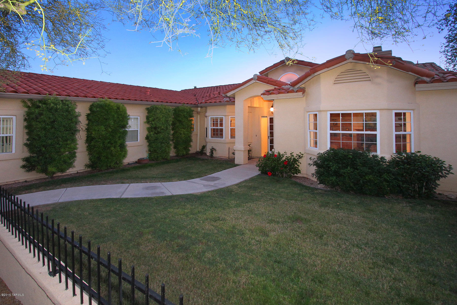 This charming home is tucked away in a quiet, private gated community, yet with easy access to all that Oro Valley has to offer. A gated and attractively landscaped courtyard welcomes visitors and leads into the generous entry warmly lit by a bronze Spanish Colonial chandelier.  ¬The gracious living room, with its’ brick hearth fireplace flanked by pine bookcases and cabinets, looks out through a casement bay window onto the courtyard lawn. The formal dining room also enjoys a view of the grassy courtyard. A comfortable family room looks out to the lovely rear yard and ancient saguaros beyond. Adjacent is a delightful and bright breakfast room, with many windows looking out to the beautifully landscaped rear yard graced by elegant mature trees and cactus, and views of the mountains beyo This breakfast room provides warm pine cabinetry buffets, storage cabinetry and glass casement doors for the upper storage areas, and opens to the fully landscaped rear yard. A deep covered patio area leads to a delightful splash pool and excellent Catalina Mountains views, and, tucked away in a corner, a large storage shed for gardening equipment. The spacious kitchen's extended greenhouse-style windows look out to the lush greenery on the home's north side, and create the perfect spot for an herb garden that our desert critters can't reach. With ample space, generous storage, plentiful countertops and a separate pantry, the kitchen offers many possibilities. A spacious master bedroom enjoys wide casement windows providing views of the rear yard's lush foliage and greenbelt beyond and, in the distance, the Catalina Mountains. The generous walk in closet is augmented by additional closet space in the master bedroom. An equally spacious master bath hosts double vanities, a separate W.C., garden tub and shower. Two additional well-lit bedrooms, a second bath and a large laundry room with casement windows providing views of the front courtyard complete this very livable home. Ready to move in and enjoy! Home has been beautifully staged by Loretta Nelson of Foothill Designs.  Home has 2 a/c units, 2 heating units and a swamp cooler.