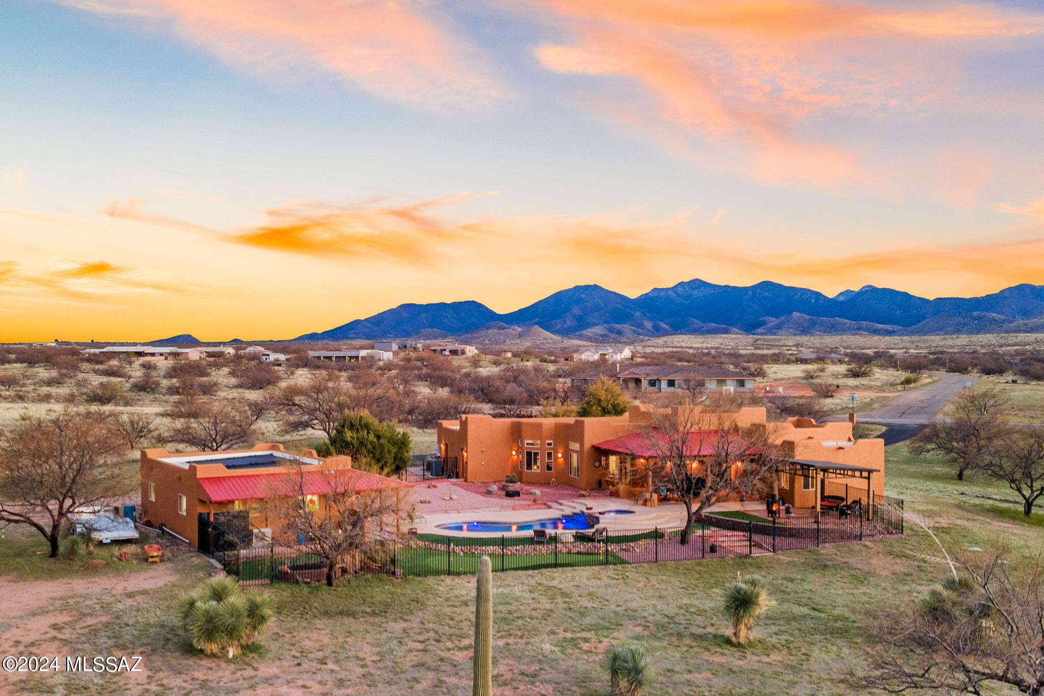 Embrace your dream of a sweet desert retreat w/ this remarkable home nestled on 3 acres in the Red Hawk at J-6 Ranch community where the beauty of the Rincon Mountains frames your daily landscape. The heart of the home lies in the spacious gourmet kitchen, featuring granite counters,& SS appliances. Enjoy dinner parties in the formal dining room & relax in your living room w/ a cozy beehive fireplace. Retreat to the primary suite which is complete with a jetted tub, walk-in shower, & double sinks. Unwind under the covered patio enveloped by desert landscaping, breathtaking views, a pebble-tech pool, spa, ramada, turf & putting area. The 831sqft workshop awaits, providing ample space for projects, ATVs or tractors. Relish in the peaceful allure of rural living & make this house, your home!