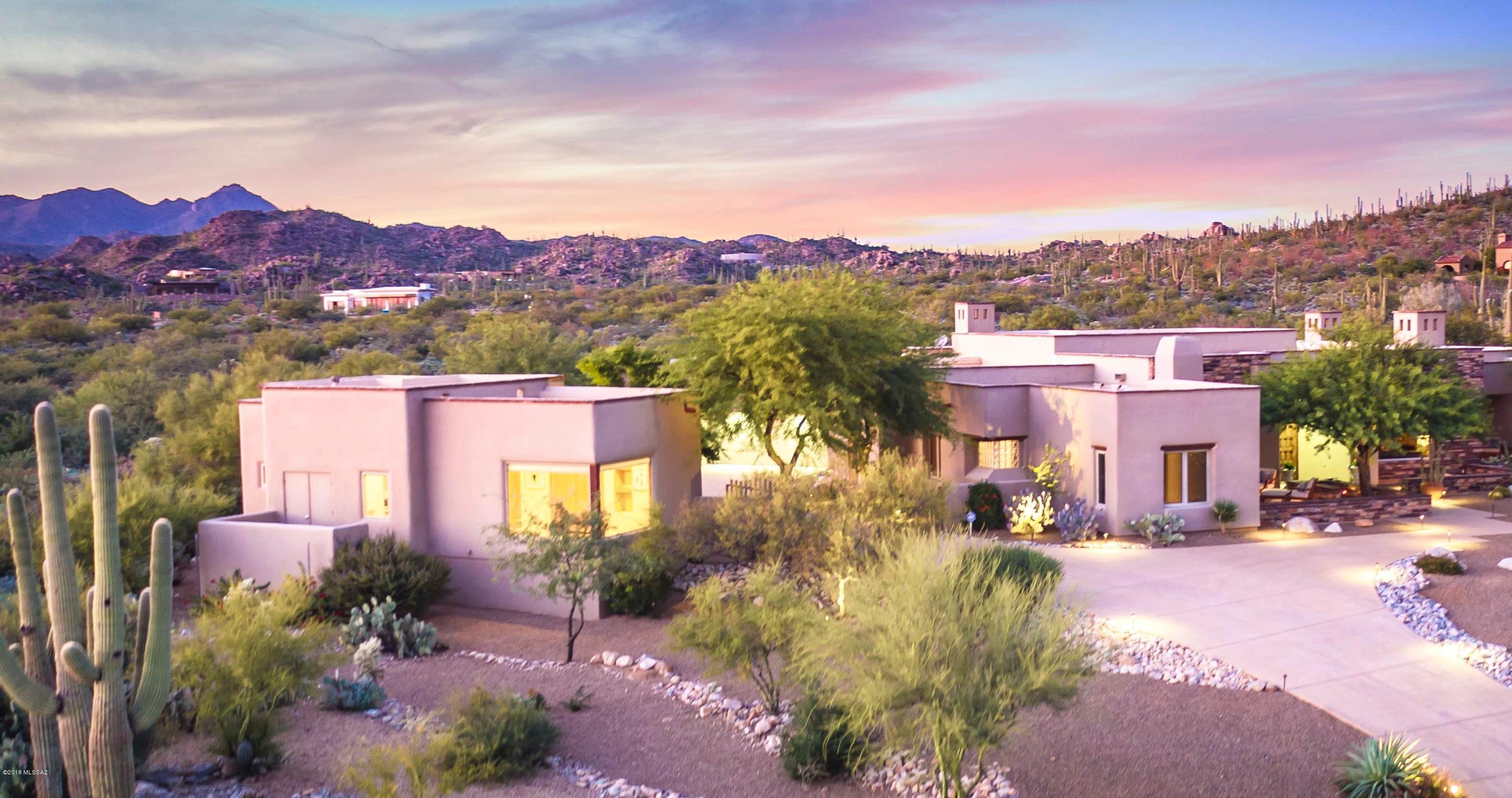 Imagine enjoying views from every window in this custom 4,037sf 4BR/3BA home+858sf 1BR/1½BA guest home w/separate entry on nearly 1 acre elevated lot in Gated Honey Bee Canyon Estates w/lap pool & oversized 3 car garage. Robinette architecture showcases traditional Spanish hacienda style while mixing the simplicity of a Tuscan estate w/modern design. Entertaining will be divine w/open gourmet kitchen w/Viking stainless appliances, Subzero refrigerator, slab granite counters, breakfast bar & casual dining area w/beehive fireplace. Master suite has fireplace, French doors to private patio, custom closet, tub/separate shower. Wood beams, corbels, carved wood pillars, stacked stone accents & surround sound.  Amazing mountain views in all directions. Truly a work of art and a place to call hom