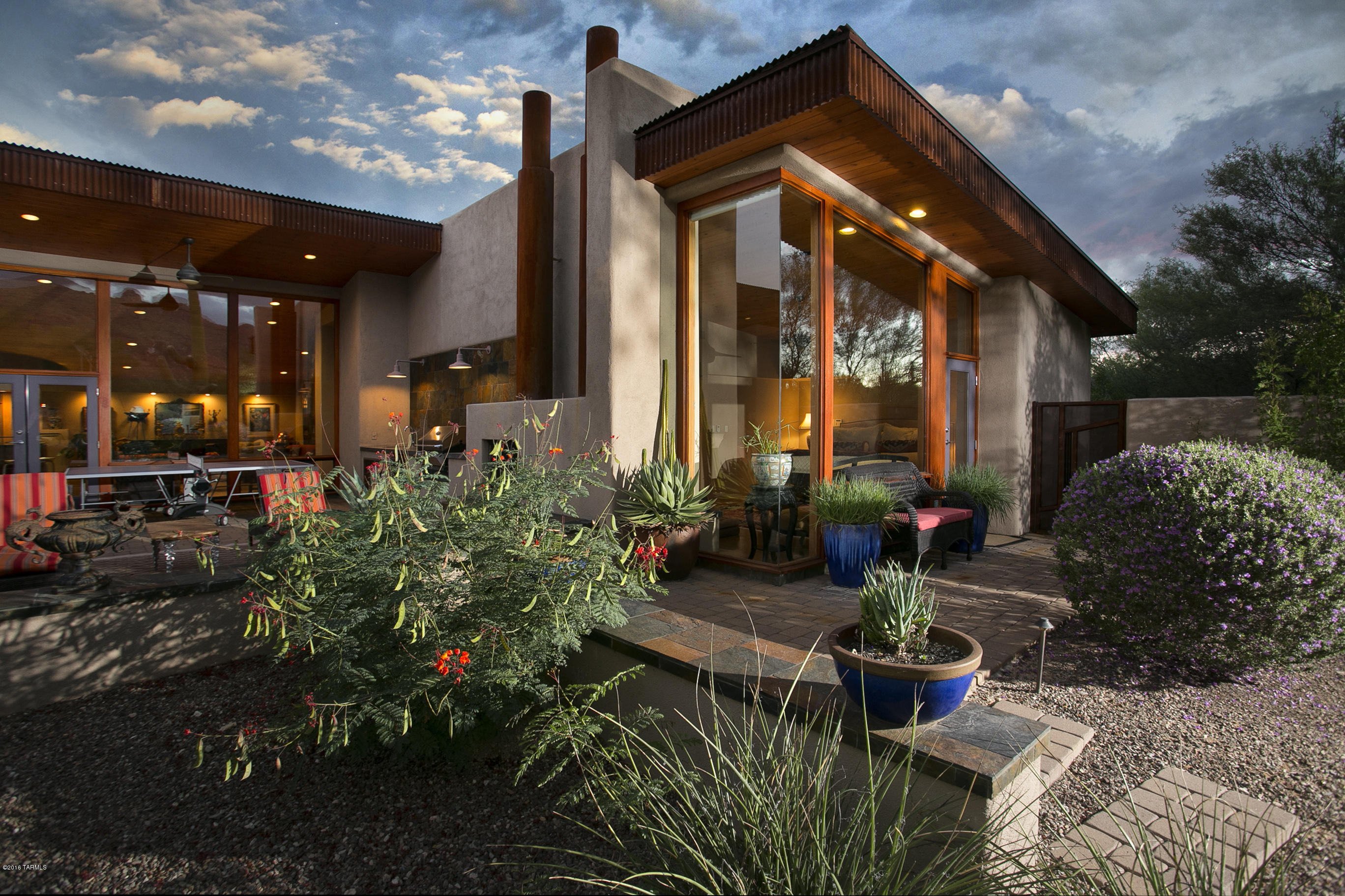 Absolutely stunning SW contemporary home designed and built by Neil Murphy of Tyson Murphy Architects. Almost a 2 acre lot nestled in mature desert vegetation. Incredible mountain views from almost every room to the North across the backyard with pool and spa which is professionally landscaped and lite to the Catalina Mountains. Home is built for indoor and outdoor entertaining. Dramatic living, dining and gourmet kitchen with center island and breakfast bar. Kitchen includes waterfall granite counters upgraded appliances. All the baths have automated toilets which just gives you the idea of how well finished out this home is. This is one of my favorite listings. This is a remarkable feel good home.
