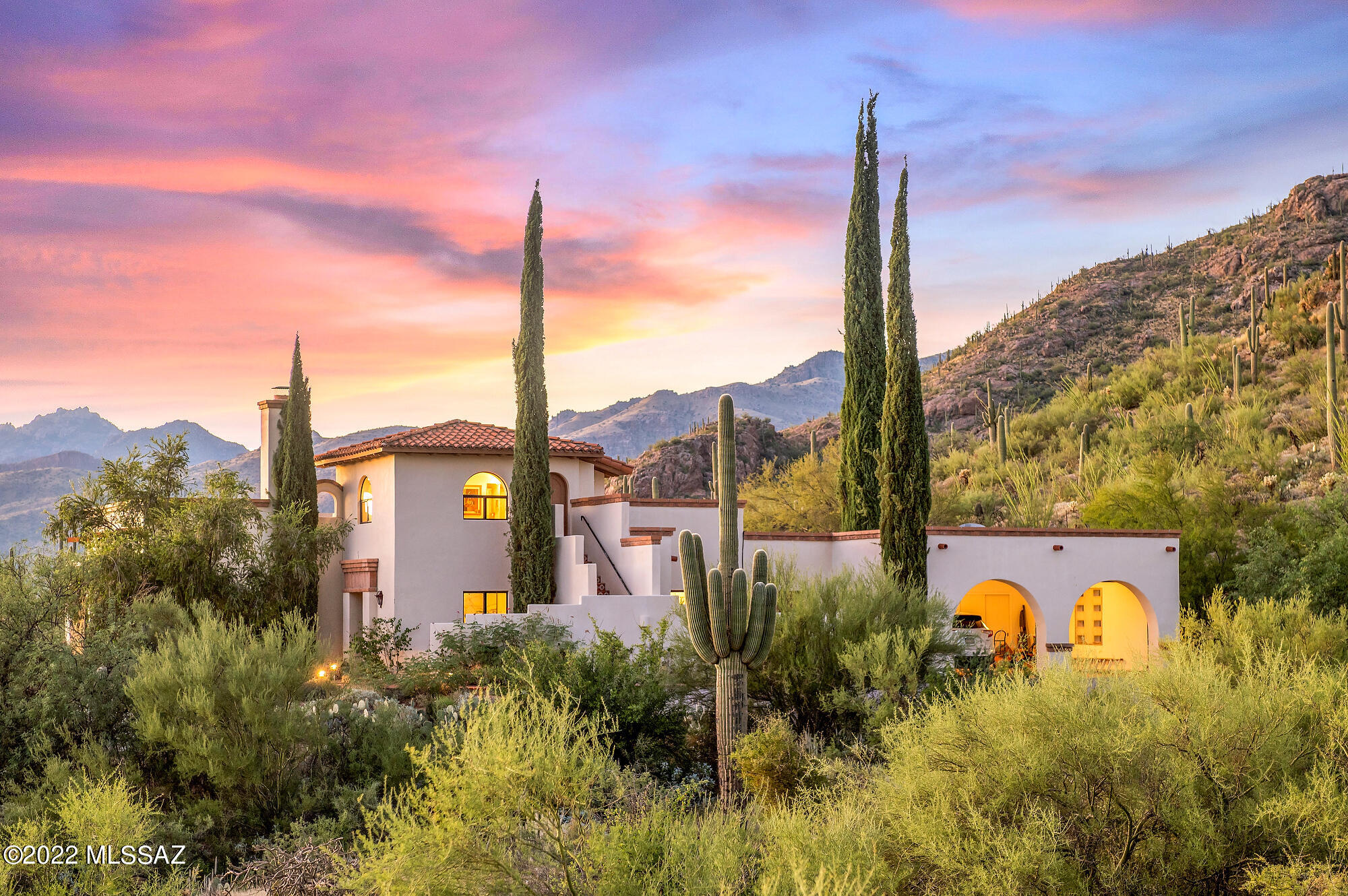 Tuscan Villa with an adjoining lot!!  Spectacular mountain, valley and sunset views in gated Redington Ranch! Properties border public land enhancing privacy. This home has all the touches dramatic arches...plank and beam ceilings and yet has a bright contemporary feel, broad sweeping views through expansive windows,  niches, warm saltillo tile and handsome bricks, and separate guest quarters. Elegant foyer sets the tone, t kitchen: features saltillo tile floors, talavera countertops and backsplashes, gas range, double ovens, double sink, built in desk and breakfast nook. Kitchen opens to beautiful landscaped courtyard with built in BBQ, fountain, and citrus/fig/peach trees. Great room has plank and beam ceiling, grand fireplace, wet bar, plantation shutters and floor to ceiling windows for breathtaking mountain and city views. Master and additional bedroom are both en suite. Vaulted atrium style family room overlooks resort like poll and patio. Tower Guest quarters with wood and beam ceiling offering 360 degree views of mountain and valley. Large 2 car garage has additional storage.  Gated Community features clubhouse, tennis courts, pool, park/pond, and horse facilities. Don't miss out on this grand villa estate!