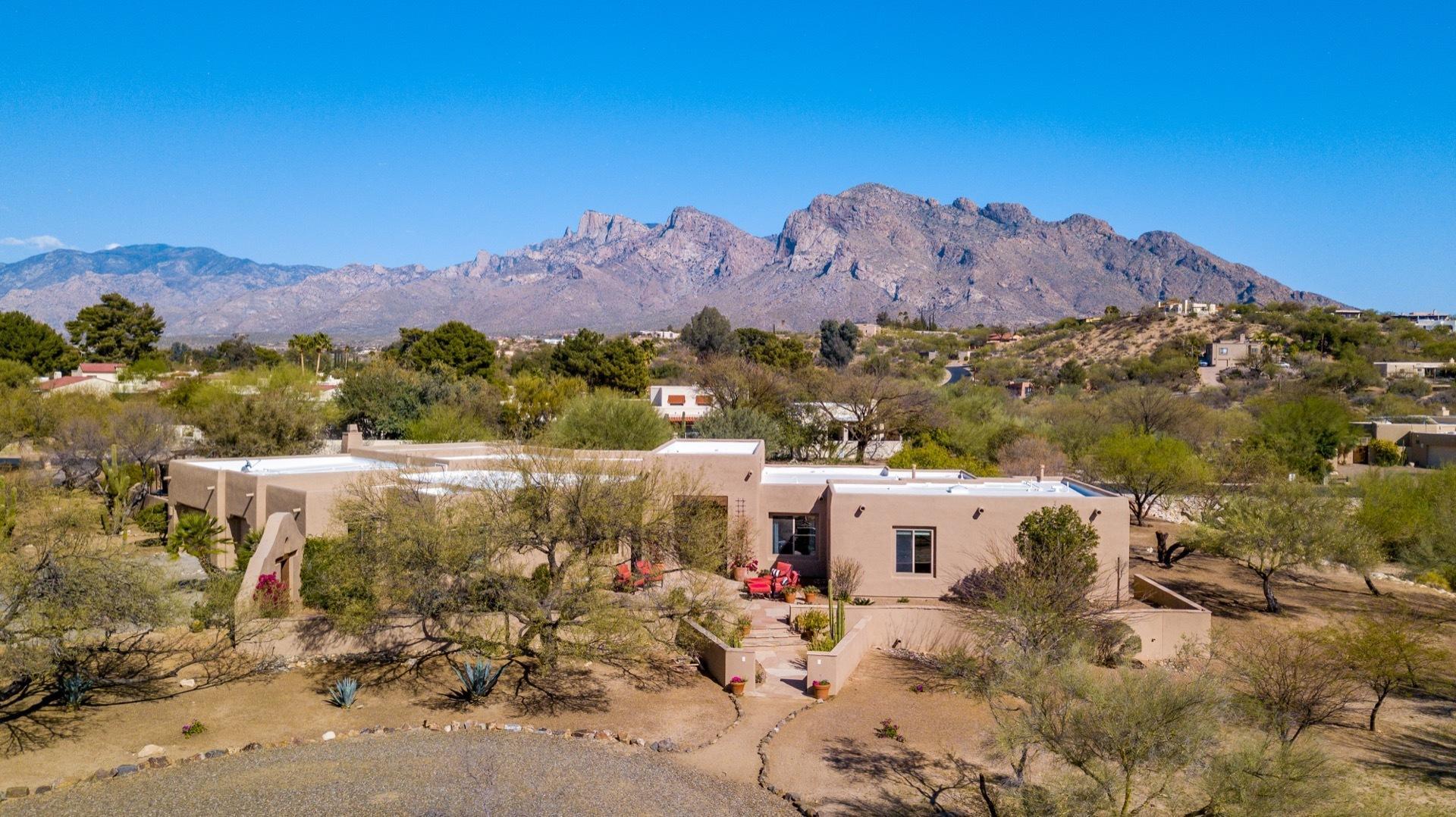 Stunning 6bd/3.5ba resort home in the heart of Oro Valley. In coveted Logan's Crossing on 3.7 acres is a very private home w/expansive patios & east facing yard that captures stunning mtn views inside & out. Perfect for a large family or multiple generations w/separate wings to give everyone space.  The heart of the home is the great room featuring a grand kitchen island, dining area w/fireplace all surrounded by vast backyard w/play structure, large turfed area, pool, spa & outdoor fireplace w/banco seating. 1000sqft shaded rear patio is entertainer's delight.  Inside you'll find travertine floors (no steps!), bedrooms w/large walk-in closets, lots of storage & spa-like baths. With direct access to the LOOP this home is a small oasis w/nearby shopping, schools and entertainment.