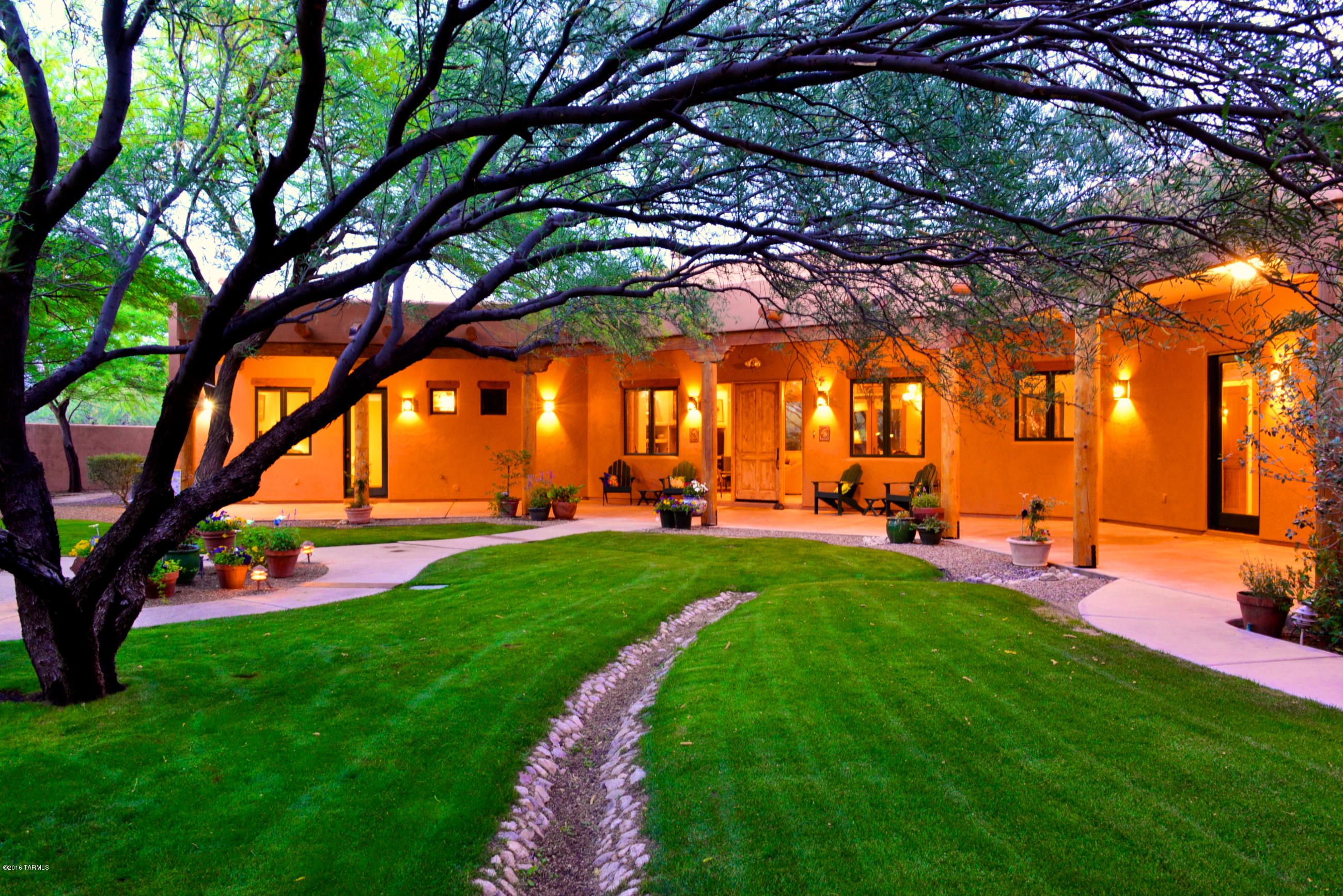 TUCSON ASSOCIATION OF REALTORS HOME TOUR WINNER! This extraordinary private estate in NE Tucson is on 3.3 acres was custom built in 2002 to maximize the views, light & ambiance. It is meticulously designed with exceptional attention to detail.  Over 1/2 acre is enclosed w includes lush lawns, trees & flower beds - all watered by a private well & irrigation system! Beautiful chef designed kitchen offers knotty alder custom cabinets, 2 sinks, granite counters, 5 burner gas stove, stainless appliances & several work stations. Magnificent 12 foot ceilings showcase viga beams, beautiful tile throughout, over 21 skylights, wood clad Pella windows & French doors-- all open to covered patios & gated courtyards. Also includes an immaculate,cooled 3 car garage.  Perfect property for horses!