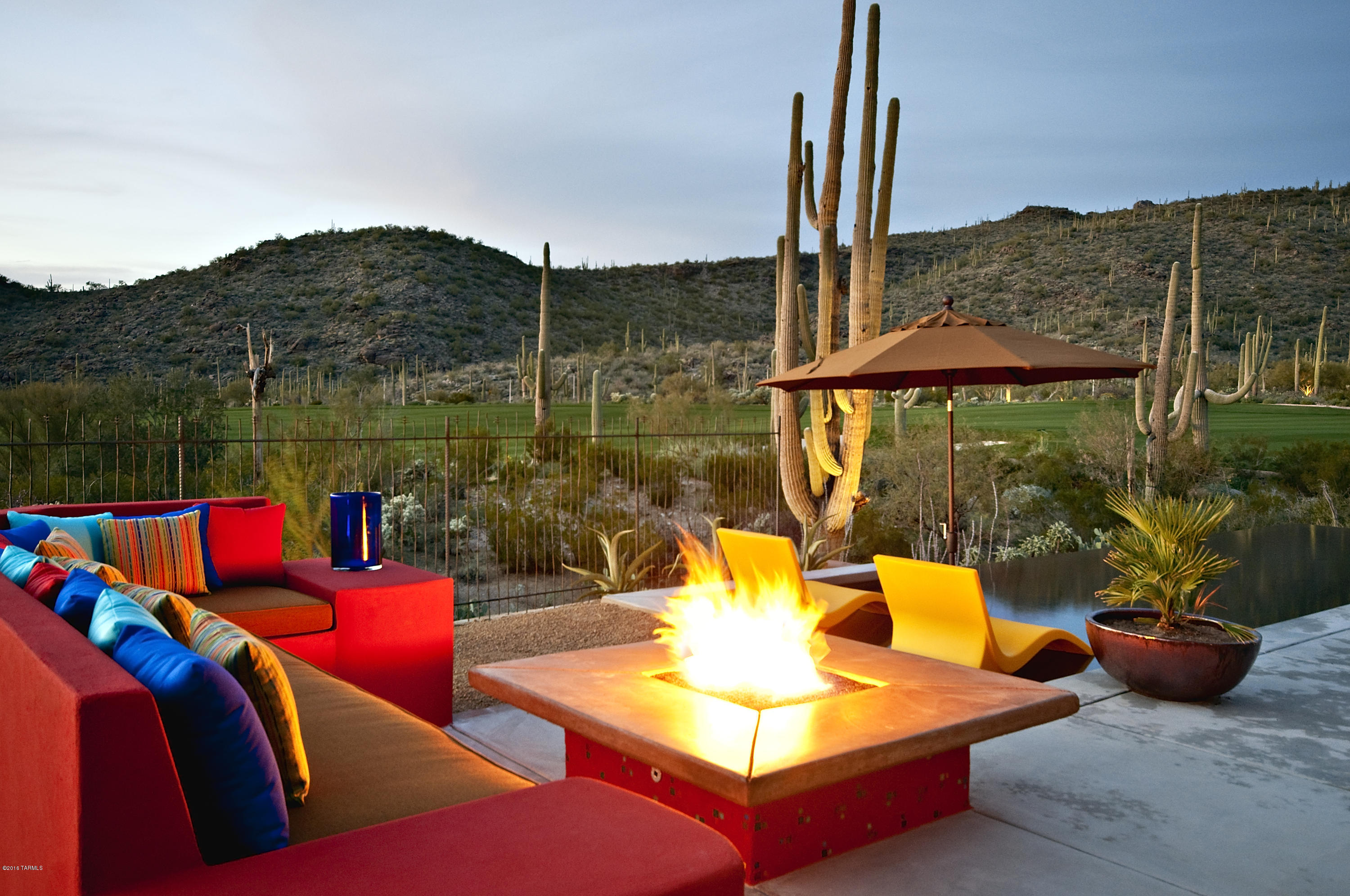 Furnished Model Home Ready for Immediate Occupancy with views overlooking the 1st fairway of the wild burro course and beyond to the Tortolita Mountains.   Amenities include a guest house with kitchen and full bathroom, motorized great room glass wall, hardwood floors, beautiful slab granite counters, sub zero and wolf appliances, two fireplaces and a spectacular outdoor living area that includes a built in barbeque, fire pit and infinity pool. Ownership includes access to The Ritz Carlton fitness center and amenities as well as the concierge services.