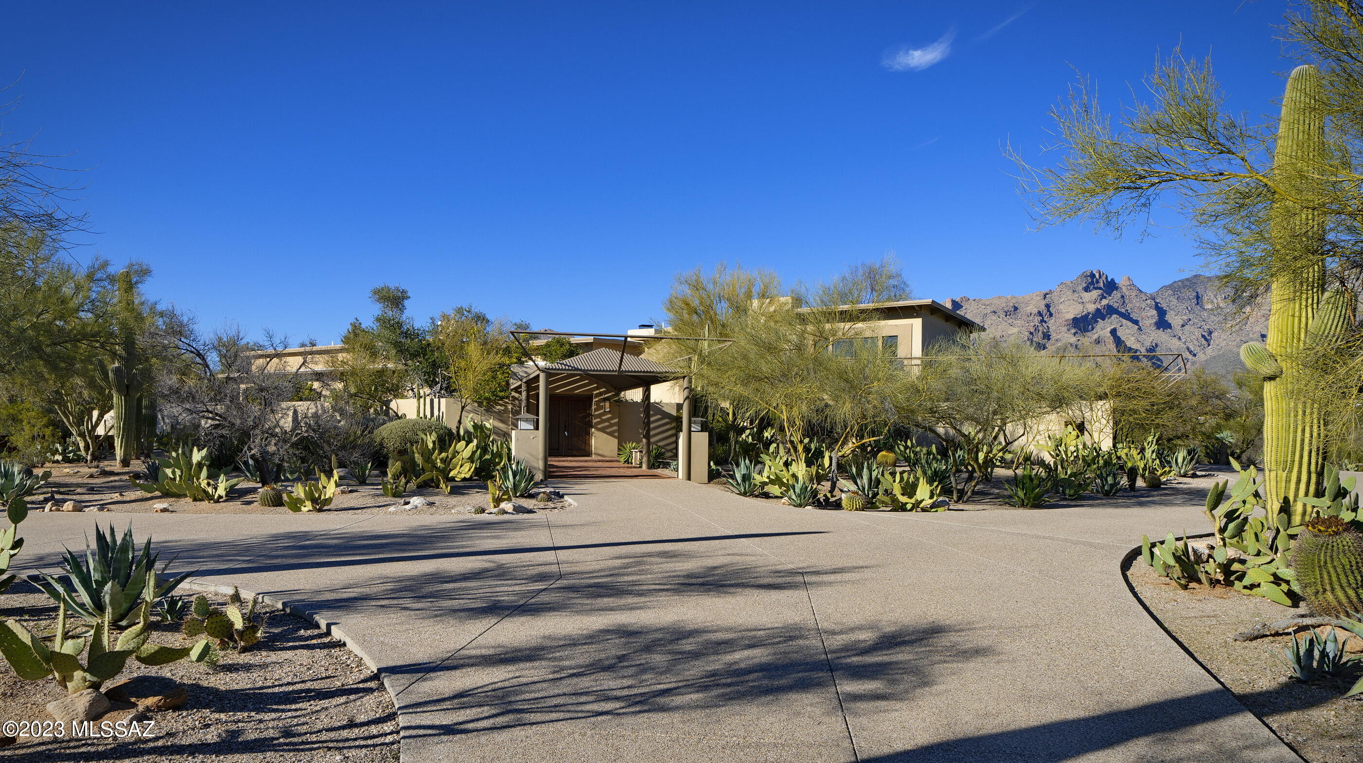 Situated on a private 3.5 acre lot in the heart of the Foothills, this impeccably maintained 4 bed/4 bath ''Joesler'' is the perfect combination of historic charm with modern updates. Completely updated with a classic and timeless design throughout. Enter through a stunning steel ramada into a front wraparound gated brick courtyard complete with citrus trees and 2 fountains.  As you enter the front door into the great room you are immediately encapsulated by soaring 14 ft. ceilings, 4-inch-thick gorgeous wood floors (repurposed from an old airplane hangar truss), an impressive wood burning fireplace, and a huge, picturesque window that perfectly frames Santa Catalina's Finger Rock. The east wing of the home features a custom chef's kitchen with stainless steel counters, appliances, large island with gas stovetop, and a 2nd fireplace.  8X6 picture perfect window captures the majestic saguaros and native Tucson plants surrounding the property. Guest bedroom with ensuite off the kitchen also could be used as an office space.  2nd floor generous sized guest suite with ensuite and large wrap around balcony overlooks the city and mountains. The west wing features another generous sized guest bedroom with bathroom and the primary suite. The exquisite primary suite has exposed beams and is lined with windows overlooking the lush courtyard and fountain. Primary bathroom with double vanities, soaking tub, walk-in shower, and walk in closet. Resort like backyard with 4 fountains, courtyards, dog run, sparkling pool/spa, and steel ramada to provide shade during the hot summer months. Extra storage space in garage and basement (which houses the utilities).  Spectacular desert landscaping throughout with endless cactus, fruit and mature shade trees.  The perfect desert sanctuary to take in the incredible sunrises and sunsets.  Enjoy minimal utilities thanks to the owned solar system, tankless water heaters, and water reclamation tanks. Prime Foothills location just minutes away from La Encantada shopping center, fine dining, and Tuscon's best country clubs.