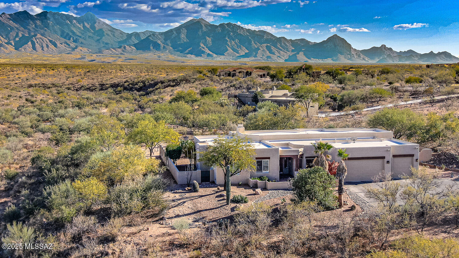 Welcome home to this stunning remodeled & updated Santa Fe classic! Set perfectly on the lot to maximize privacy, the home offers unparalleled views of the majestic Santa Rita Mountains! Step out to one of your private patios and enjoy your favorite beverage while watching the various wildlife come and go.  The expansive covered patios invite outdoor living year-round, and are surrounded by meticulous low care landscaping that make for a resort like experience in your own backyard! The remodeled interior features a cozy living room w/fireplace, a great room style dining, kitchen and family room area with an abundance of granite, top of the line appliances, and custom knotty Alder cabinetry. Whether enjoying a casual evening at home or cooking for guests, the kitchen is both functional stylish. The primary suite boasts beautiful mountain views, has its' own exit to a private patio and custom plantation shutters to close out the day when ready. The spacious 3 car garage has a workstation area, plenty of storage space, epoxied floor and an oversized garage door & extra length for your oversized vehicles.  This Santa Fe Classic waits for the discriminating buyer who relishes superb quality and extraordinary privacy.  With a short commute to Tucson, you'll come home to your own desert oasis!  See the documents tab in the MLS for detailed update & remodel information.  Most furniture is availalbe by SBOS.