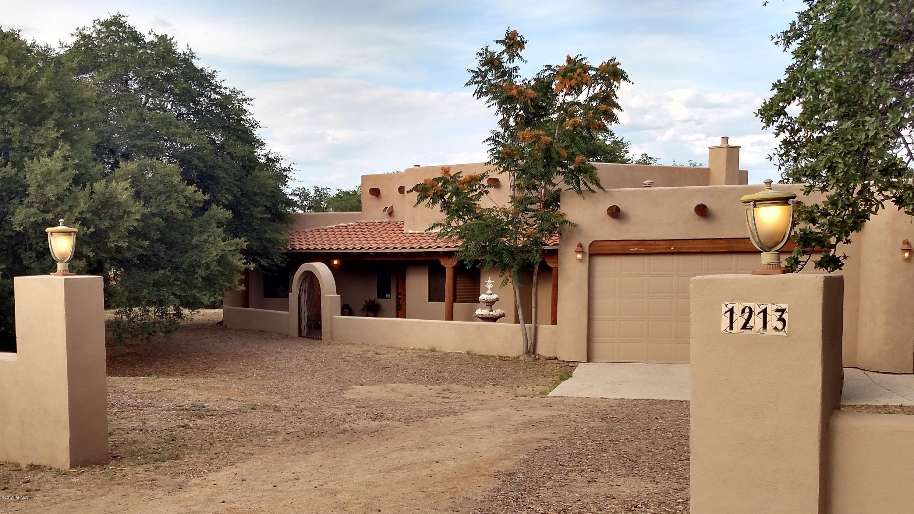 Custom Santa Fe with wonderful southwestern design throughout on beautiful half acre lot with huge oak trees. Enjoy the perfect year round weather in Oracle, AZ. Elevation at around 4300 ft. makes the summers cooler and the winters are still very mild. Just 20 minute commute to Tucson. This home has custom cabinets throughout, 2 fireplaces, and an oversized 3 car-garage. Call today to see this home.