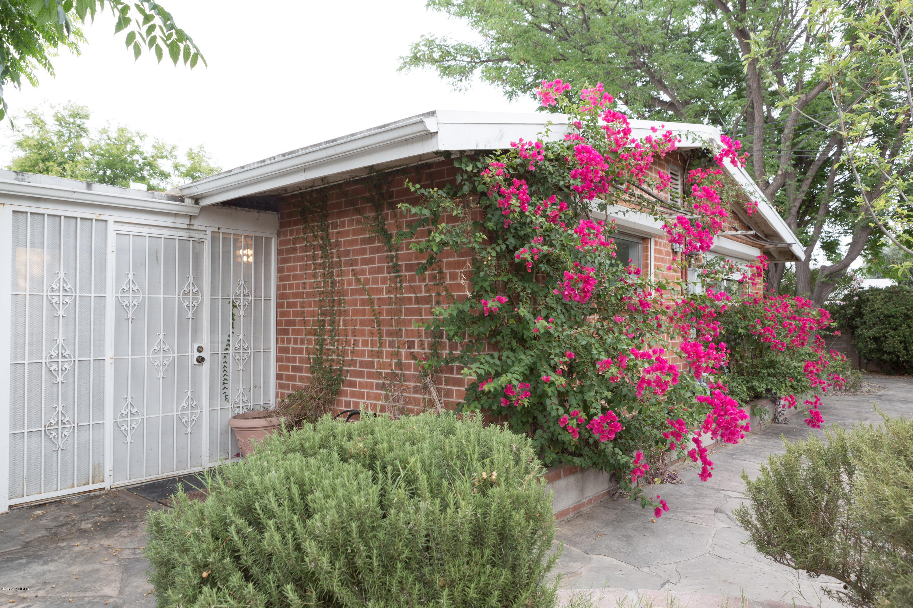 2032 E La Madera is located close to shopping and just minutes from the U of A. This well designed floor plan has 3 bedrooms and 2 baths with a fireplace that accentuates the large living room and dining area which leads into the galley kitchen, breakfast nook and utility room. The skylights and large windows brighten up the home. Three patios lead to mature landscaping in the large surrounding yard. Unique to this desired neighborhood is the 2 car garage, a much desired amenity which includes easy access to the home and a large storage space. Make an appointment to see all this home has to offer...you will want to move right in!