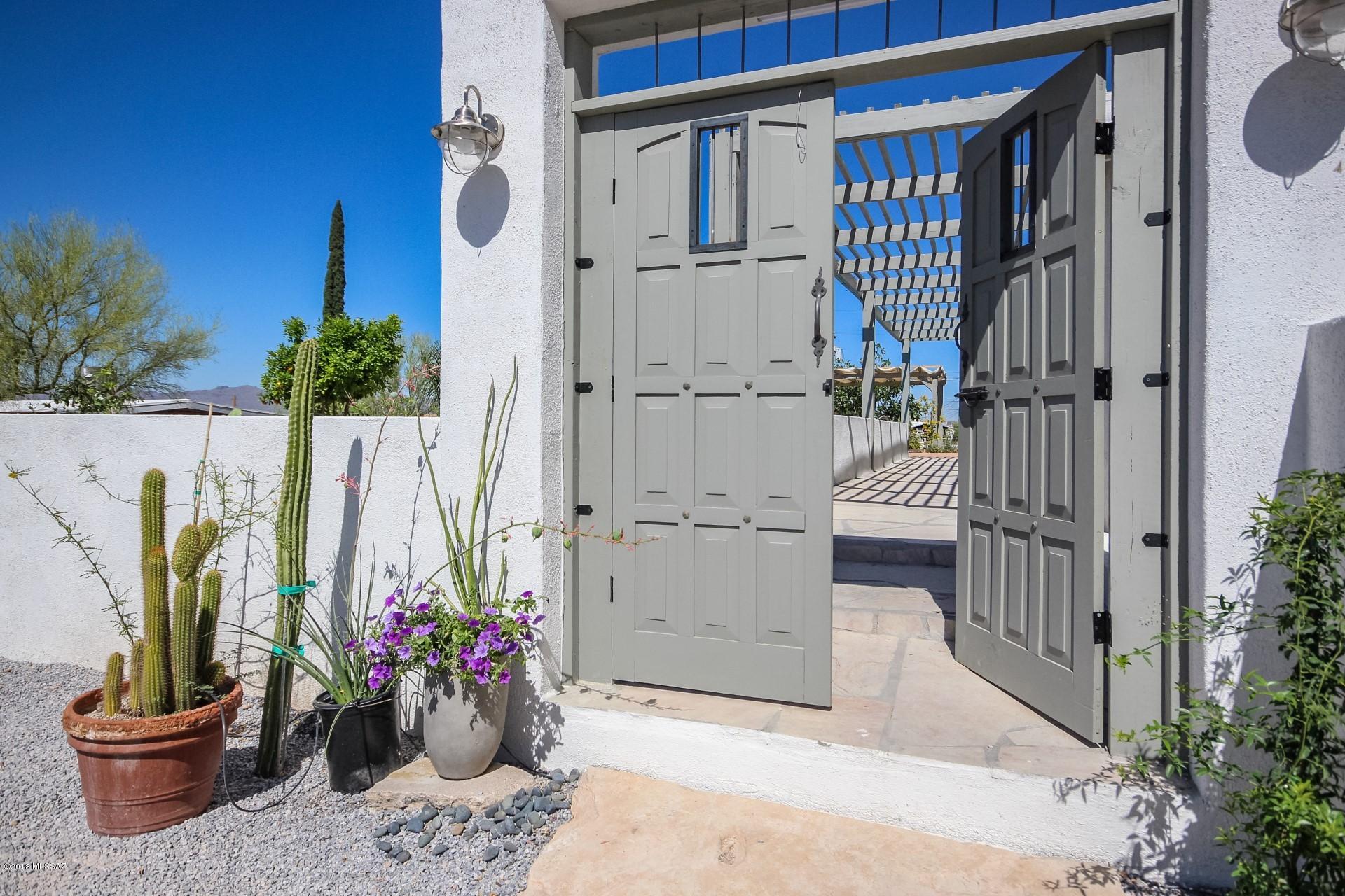 Seller will accept and counter offers between $390,000-$410,000.  Gorgeous Mountain and city views Absolutely stunning home with a perfect twist of contemporary and modern farmhouse! Exposed beam ceilings and panoramic windows let in all the natural AZ sun light! One of a kind custom fireplace in living room. Eat in kitchen is complete with farmhouse sink, center island with breakfast bar, subway tile backsplash, and custom cabinetry. Master retreat has tile flooring, ceiling fan, and a french door exit to backyard. Full bathroom has single sink vanity and clawfoot tub with shower. Spacious walk in closet! Private office room has wall to wall windows. Backyard features oversized pool, flagstone deck, brand new pergola, desert landscaping, covered patios, and plenty of room to dine alfresco