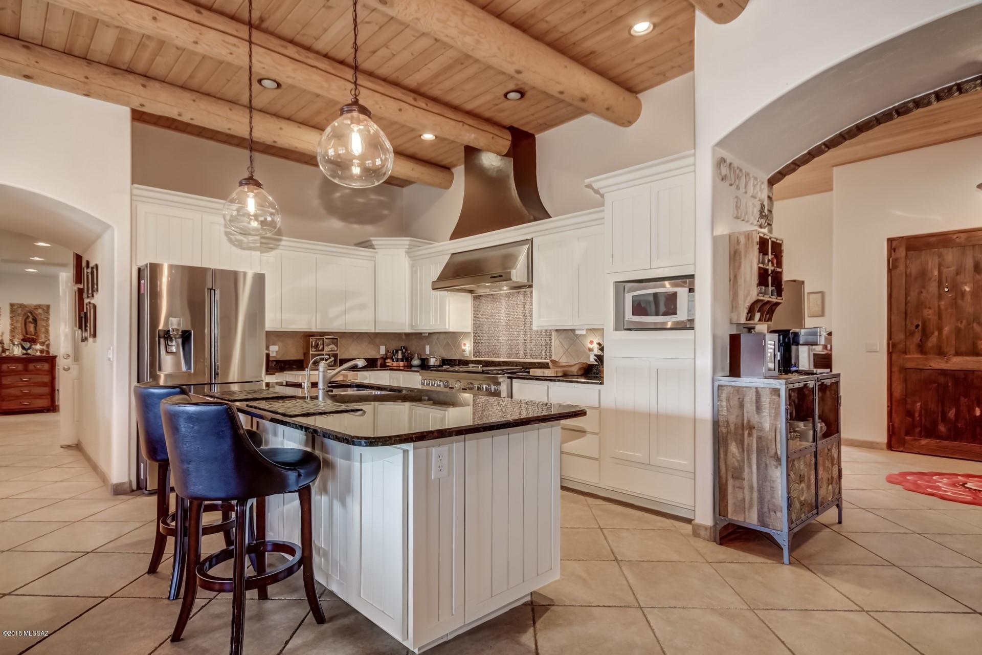 Come fall in love with ''Desert Perfection''! Outstanding Home nestled on 5 acres with breathtaking Mountain Views, 3 car garage, and RV parking. Stunning chefs kitchen features center island, granite counters, breakfast bar, exposed wood/beamed ceiling, plantation shutters/blinds, tiled backsplash, SS appliances, and plethora of white cabinetry. Perfect Home for entertaining inside and out. Cozy brick family room fireplace, patio access, and beautiful tile floor set on the diagonal. Formal dining area, upgraded lighting, and impressive double front doors. Charming master retreat offers patio access, coffered ceiling, plush carpet, plant shelves, and private upscale en suite. Large laundry room, utility sink, storage cabinets, ample bedroom closets, and 4 baths. Enjoy the sparkling pool... spa, covered patio, two gazebo's, large patio, and Majestic Mountain & natural desert views. See it...Love it...Live it!!