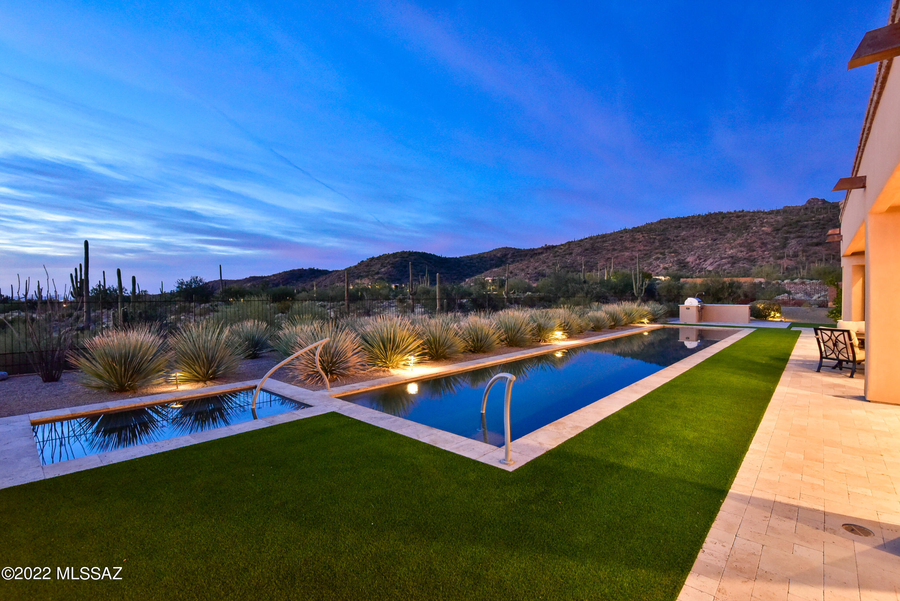 Stunning custom home within the gates of The Ritz-Carlton, Dove Mountain. Boasting sophisticated and neutral design choices. The Chef's Kitchen features Sub Zero & Wolf Appliances, full wine fridge & plenty of space for entertaining. Disappearing window wall at Great Room shows off impressive backyard, complete with a lap pool, spa, outdoor kitchen and fireplace. Enjoy unobstructed sunset, golf course, city and mountain views. This home comes complete with main bedroom, two large additional guest suites and an oversized den that can be used as an office space, second living room or additional guest suite. Homeowners enjoy access to The Ritz-Carlton Resort & golf club, along with home management and concierge services.