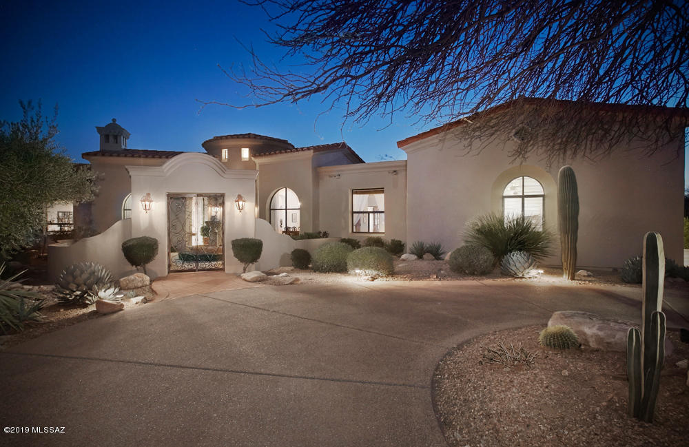 ONE OF THE MOST CHARMING AND INVITING HOMES IN COVETED PIMA CANYON.  DESIGNED TO CAPTURE THE WARMTH AND CASUAL LIFESTYLE OF TUCSON.  CUSTOM BUILT 3725 SQ.FT ON A 1.3 ACRE LOT FEATURES  3BRs/4BAS, PLUS OFFICE.  THE GREAT ROOM W/FRENCH DOORS OPENS TO A LARGE COVERED PATIO W/STONE FIREPLACE AND LARGE  POOL AND SPA.    SPACIOUS MASTER SUITE BOASTS A 2-SIDED FP, JETTED TUB, STEAM SHOWER AND HUGE CLOSET.   TWO GUEST ROOMS HAVE MOUNTAIN VIEWS AND SEPARATE BATHS.   HEWN BEAM CEILINGS,  ROTUNDA FOYER, BRICK FLOORING, WROUGHT IRON DOOR AND 4 STUNNING FIREPLACES ARE JUST A FEW OF THE MANY FEATURES.