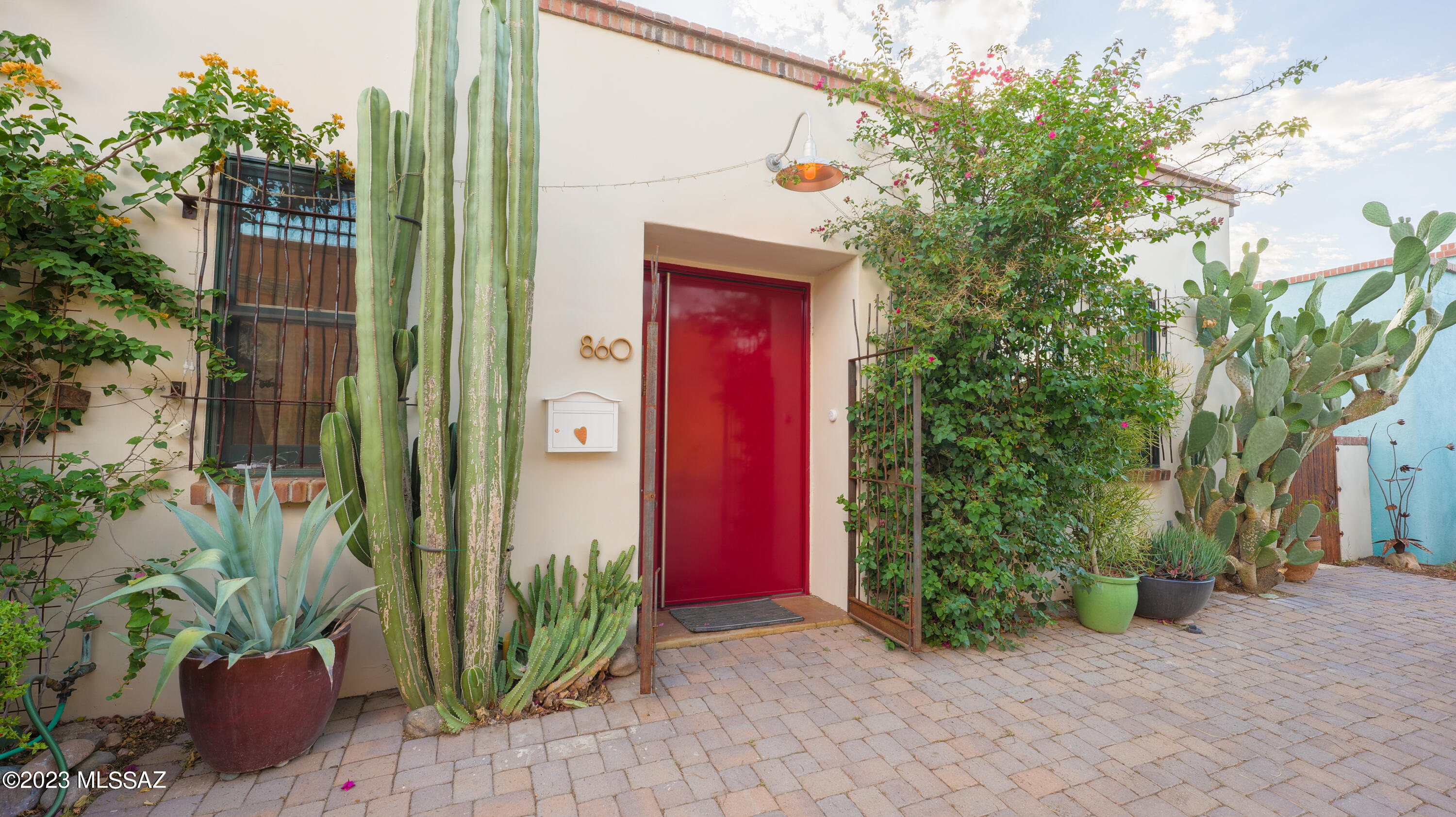 Downtown living at its finest! This quintessential Barrio home is located on one of Tucson's most photographed and painted blocks in historic Barrio Santa Rosa. 

From the moment you enter through the large custom door, you are welcomed by vibrant colors and natural light. A large open concept living and kitchen area provide a wonderful gathering space. Walk through the Arizona room into the large courtyard, which the home is artfully designed around. Here you will find a water feature and plenty of space for entertaining, or just appreciating your peaceful oasis in the heart of downtown. Additionally, there is an additional side yard with irrigation to build your garden. 

With three bedrooms and three bathrooms, there is space to host or for a beautiful home office. The primary bedroom area has a generously-sized laundry room with sink and storage, a walk-in closet, and its own entrance to the courtyard. 

For those needing storage and/or work space, this home features a large shop area with an industrial vent hood, as well as an attached garage. 

This home truly has it all - proximity to downtown amenities, generous square footage, outdoor spaces with mature vegetation, storage/work space, and high-end appliances which will all convey. If you have been looking for the real downtown Tucson living experience, your search ends here!