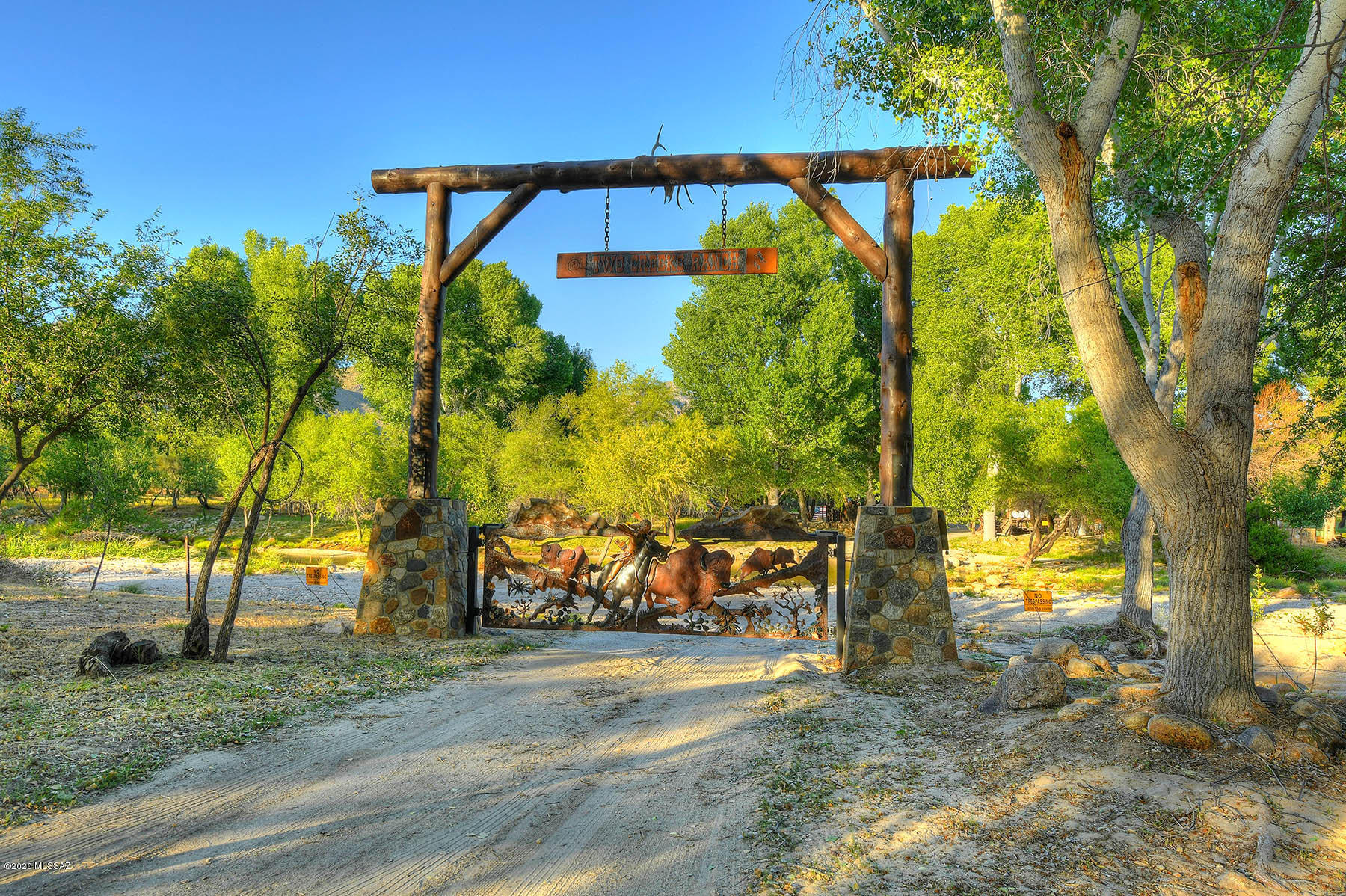 Custom adobe, tucked behind an artisan-crafted private gate & perfectly sited on 22 lush foothills acres bordering Sabino Canyon & Canyon Ranch Resort. Framed by 2 natural creeks, mature cottonwood trees & saguaro-studded vistas, a stones throw from shopping & dining, yet peaceful & secluded. 24 ft wood beamed ceilings, walls of windows capture city & mountain views, mesquite wood & gleaming concrete flooring, dramatic fireplaces, home office, private balconies at every guest bedroom, chef's kitchen, rec room, pool house, 5 car garages, & a rare artesian well. All in District 16 & never before on market.  List of amenities available.  Imagine living inside Sabino Canyon National Park, in a gorgeous luxury adobe home, 5 minutes from dining, golf, shopping & resorts - MORE INFO IN DOCUMENTS