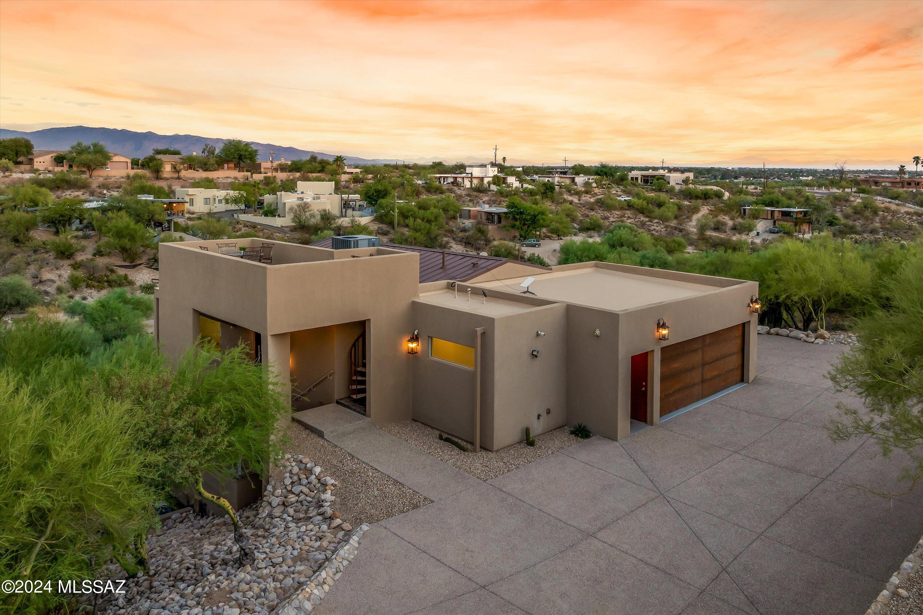 Industrial Modern Beauty located in the heart of the Catalina Foothills! Renovations & Redesign completed in 2019.  Nestled high on .87 acres w/ Both City & Mountain Views! Great floorplan w/ 2 Primary Bdrms. 3,607 square ft w/ 4 bdrms & 5 bathrooms. Features Custom Metal front Door, High Ceilings, Metal Roof, Nest AC Control, Dual zone AC, Newer HVAC, Built in BBQ, Ceiling Fans Throughout, and security features.  Chef's kitchen w/ GE Profile SS Appliances, built-in Refrigerator, Double convection/Micro Oven, Wine Fridge, Butcher Block Island. Quartz counters throughout kitchen & bathrooms. Primary Bdrm has Custom birch walk-in closet with storage. Two huge slate balconies, heated pool & spa, additional patio off Primary bdrm along w/ rooftop terrace help make this an unbelievable find!