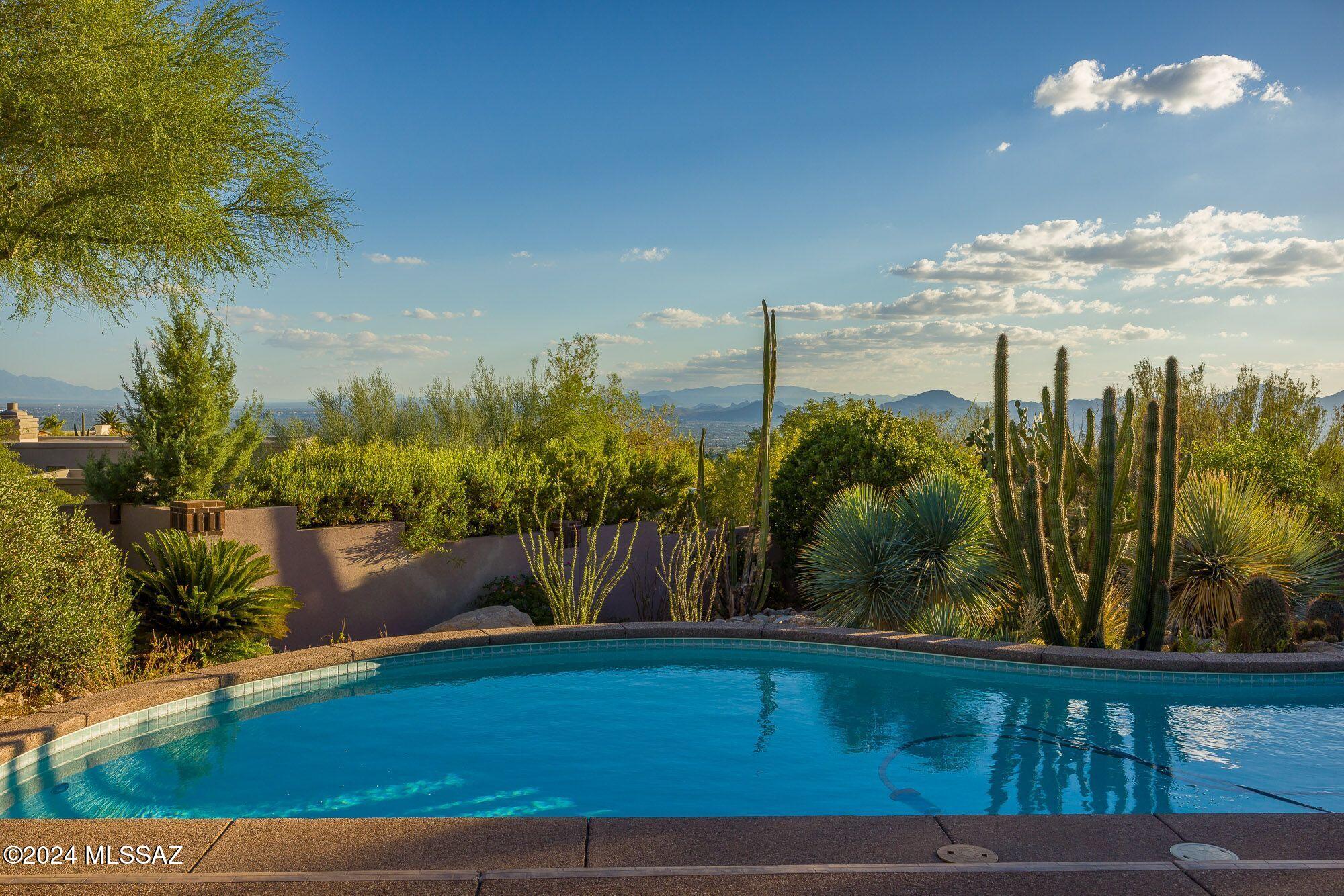 Awesome property in the prestigious guard gated Cobblestone community - 'breathtaking views of the Catalina Mountain and City lights. This home offers very spacious rooms throughout, 3 bedrooms and 4 bathrooms, front entry hall welcomes to a grand great room with formal dining, library/media room, fireplace, state of the art kitchen, tavera stone floors in all areas except bedrooms, ceiling fans, alarm system, large covered patio with attached pergola,  that offer sweeping views of mountains and city, sparkling pool & spa.