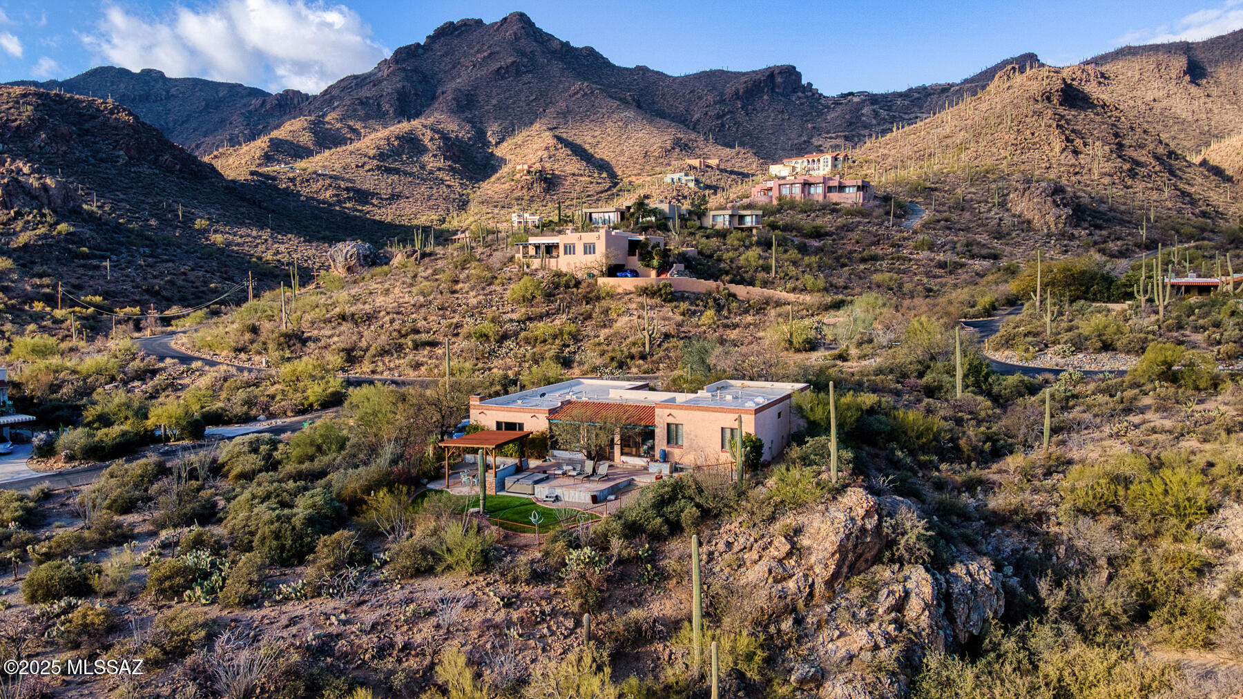 Discover a peaceful haven in the sought-after Trails End community of Tucson. This inviting 3-bedroom home, nestled in a serene canyon setting, offers comfortable living amidst the beauty of nature. Enjoy the tranquility of this established neighborhood while remaining conveniently close to all that Tucson has to offer.
The updated kitchen creates a warm and welcoming atmosphere, perfect for gatherings. The thoughtfully designed layout maximizes comfort and showcases the natural light and stunning canyon views. Three bedrooms and two updated bathrooms provide ample space for relaxation and rest. Step outside to a private oasis designed for enjoying the majestic desert landscape. Relax under the ramada, create culinary delights on the built-in BBQ & pizza oven, or unwind under the stars in the hot tub.