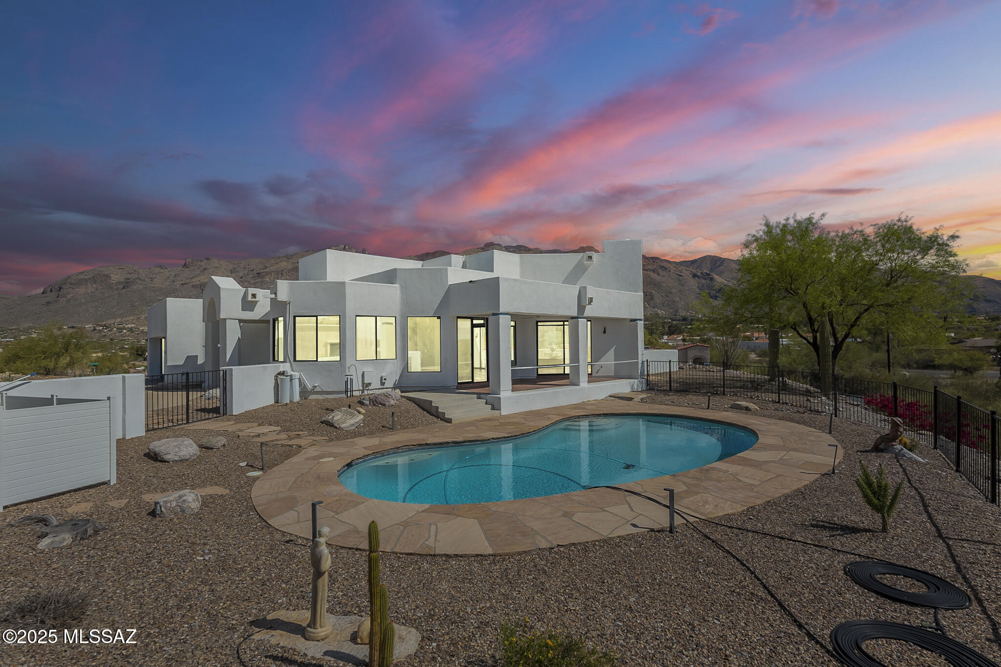 Immaculate and delightful, set on a rare captivating high view lot w/expansive windows; Panoramic and spectacular City and MT Views!  In gated community of Kachina Hill, graded for Engineered drainage with space for addition, finished by striking Rip-Rap and crushed granite. South facing yard w/sparkling private pool and covered red brick patio overlooks amazing City Views; Spacious Master suite over looks the Majesty of the Catalinas, natural flag stone flooring thru out; over size Soaking tub and separate shower, Dual pane windows w/motorized custom shades, Cook's kitchen w/island; plus Community Pool and Spa; All anchored on.65 acre lot; PRIDE OF OWNERSHIP! PLEASURE TO SHOW TO-DAY!