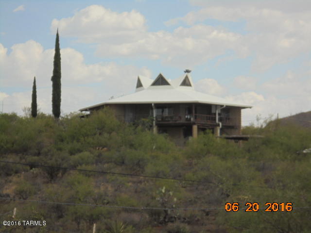 Very unusual attractive octagon home on the hill just south of historic Tombstone. This home is being sold with two lots. There is a large apartment in the full basement and this place has city water. Home is built on a hill so basement apartment has a patio and views also. You must see this exciting place to appreciate it. The views are totally awesome.