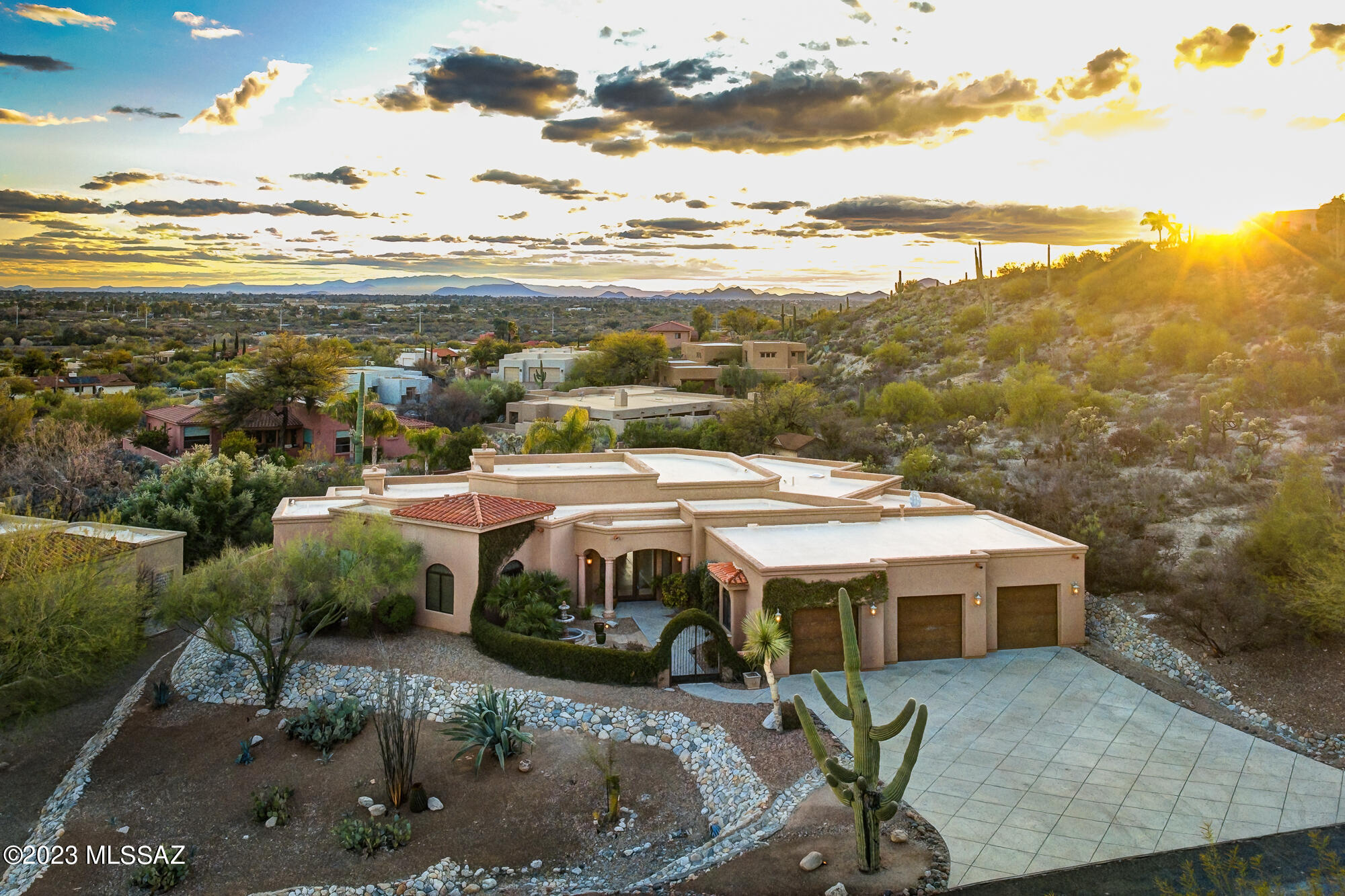 Beautiful home located in the desirable Gated Community of River Gate Estates on large, elevated lot with panoramic mountain & city views. As you enter, you'll love the lush landscaping surrounding courtyard & views. With 3651 sq ft of living space this spacious home boasts formal living & dining room with dramatic 15 ft high wood beamed ceiling, fireplace & wood plank flooring. Gourmet kitchen w/custom kitchen cabinets, granite counter tops & stainless-steel appliances. Enjoy private, elegant primary bedroom suite with fireplace, walk-in closet and private covered patio. Jacuzzi tub in primary bathroom great for relaxing. As you step outside, you'll love the heated pool with water fall feature and spa. Covered porch, built-in BBQ, firepit, grass & zipline make this back yard great for entertaining. Oversized 3 car garage w/extra storage. Incredible Catalina Foothills location within minutes of the best shopping & restaurants Tucson has to offer. Close to world-class golf resorts, country clubs, hiking, running & biking trails including Rillito River Path/The Loop which offers 130 miles of paved trails, Whole Foods shopping plaza, Basis school and much more!