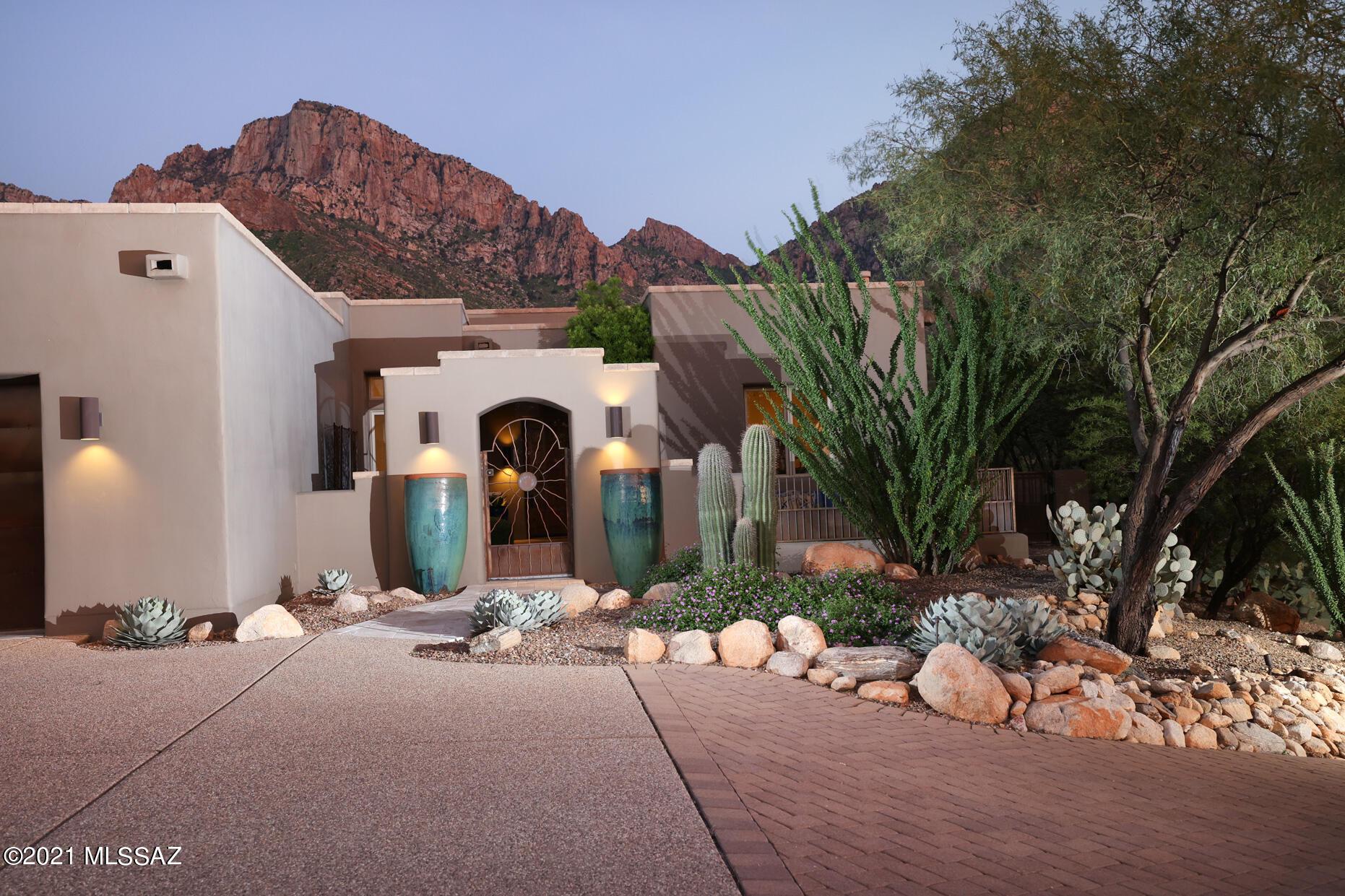 Spectacular mountain, sunset & city light views from this gorgeous hilltop estate bordering Nat'l forest & designed by well known Ron Robinette boasting unparalleled sophistication & luxurious finishes.  Fabulously curated front crtyd w/gas FP & city views set the stage as you enter the foyer w/a prominent rounded mud adobe wall and expansive windows magnifying the mtns behind. Dream kitchen w/top of the line appliances, cabinetry & chiseled edge granite island & dining area with, you guessed it, more mtn views.  Lg cov'd patio opens to the pristine bkyd w/pool, hot tub, wood burning FP & grilling area w/sink. Stylish southwestern baths, sep liv rm, monster ofc, long brick paver drive & extended 2 car garage has plenty of storage space or room for gym equipment round out this superb home.