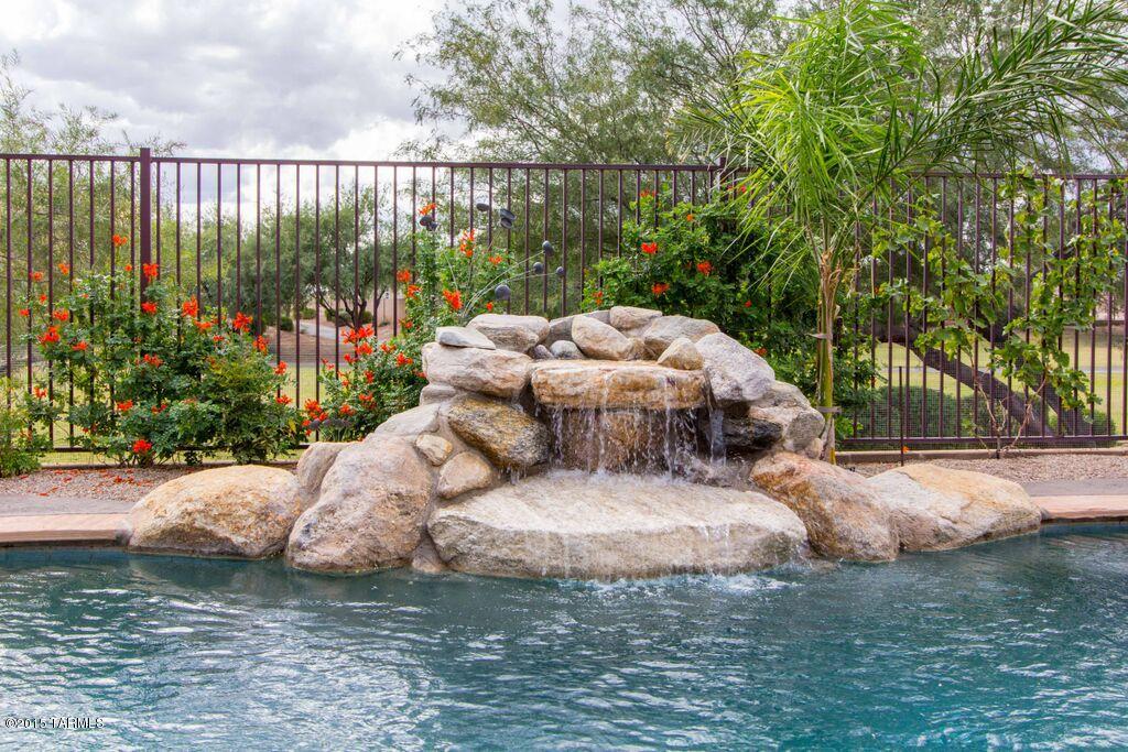 One of the finest properties available in Gladden Farms; no neighbors behind or to the east; pebble-tec self-cleaning pool with waterfall; fire pit and large covered patio; home and backyard wired for surround sound; open view security fence looking into green space; 80” TV niche in great room; exterior painted in Oct. of 2015; new ceiling fans and lights; oversized garage with built in wood shelving and work bench