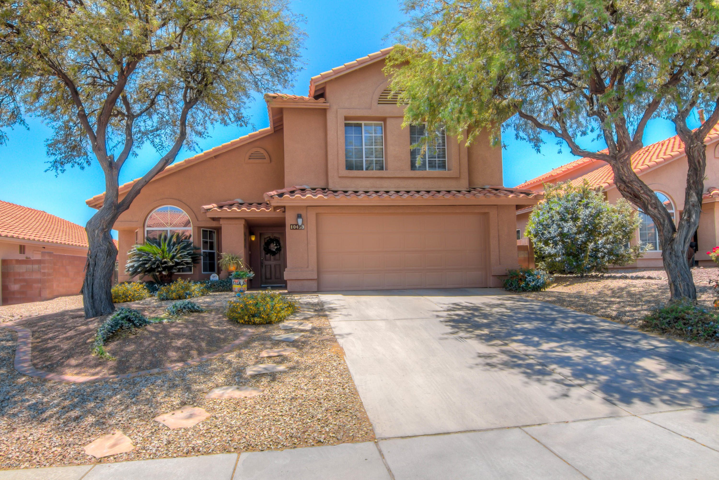 Gorgeous move-in ready home with panoramic views. The home features soaring ceilings, a gourmet kitchen with granite countertops, a breakfast bar and dining nook. Upstairs, floors are upgraded solid surface, upgraded bathrooms, and the look and feel of a model home! 4 bedrooms and 2 bathrooms upstairs and a bedroom and bathroom downstairs make this a perfect home for those needing some extra room to grow or for mutli-generational living! The backyard is beautifully landscaped and has a covered patio and built in bbq grill and seating area. Don't miss this spectacular home in the heart of Oro Valley and close to schools, parks, shopping and more!!