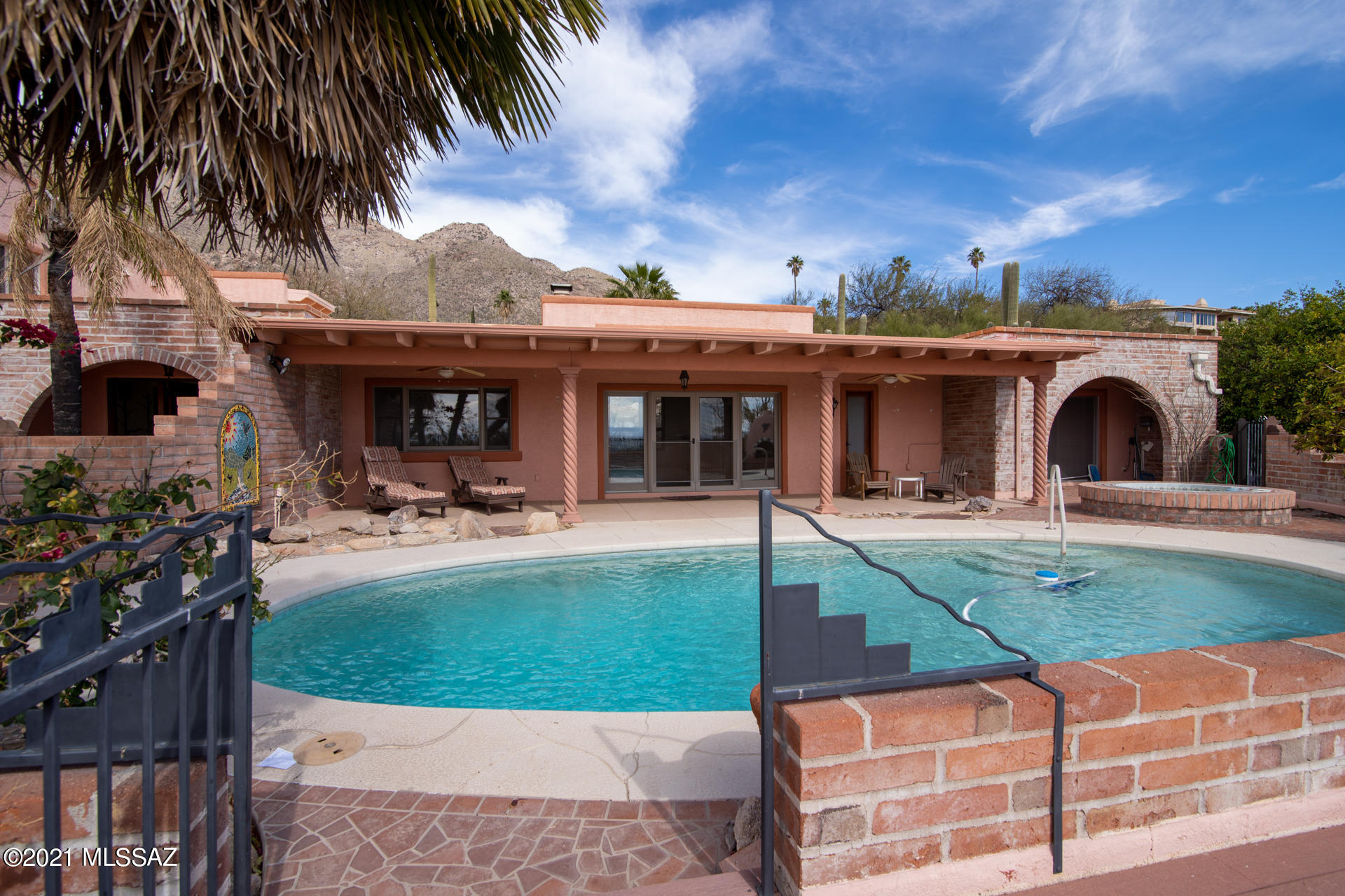 Quintessential adobe block, territorial estate in Skyline country club located on the 2nd Fairway with commanding city views all the way to Downtown Tucson. You will enjoy the spacious master suite and bath with see through fireplace. The great room with its soaring ceilings and picturesque windows captures both mountain and city views. Pool, Spa, Driveway constructed of Pavers and Mini Citrus Grove are just some of the outdoor amenities you will enjoy. More pictures and floor plans to come.
