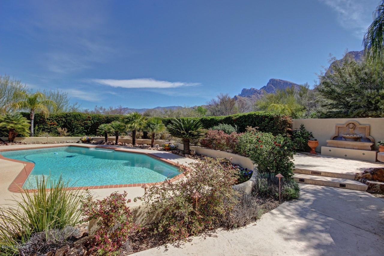 SPECTACULAR AND UNIQUE 2 FAMILY HOME NESTLED AT THE BASE OF PUSCH RIDGE. PRIDE OF OWNERSHIP REFLECTED THROUGHOUT IN LUXURY UPGRADES! X-LARGE MASTER SUITE HAS ITS OWN FIREPLACE, SPACIOUS FAMILY ROOM HAS A CUSTOM BAR. PERFECT FOR A LARGE OR EXTENDED FAMILY- SECOND LIVING AREA HAS KITCHEN, FULL BATH, PRIVATE ENTRANCE AND PATIO. MANICURED PARK-LIKE GROUNDS ARE GORGEOUS, AND VIEWS ARE SPECTACULAR. SPARKLING HEATED POOL AND OUTSIDE ENTERTAINMENT AREA WITH BBQ. TOO MANY UPGRADES TO LIST THEM ALL. 5 GARAGE SPACES! CHECK THIS OUT FOR UNIQUE CHARM AND VALUE.  SELLER MAY CARRY WITH SUBSTANTIAL DOWN