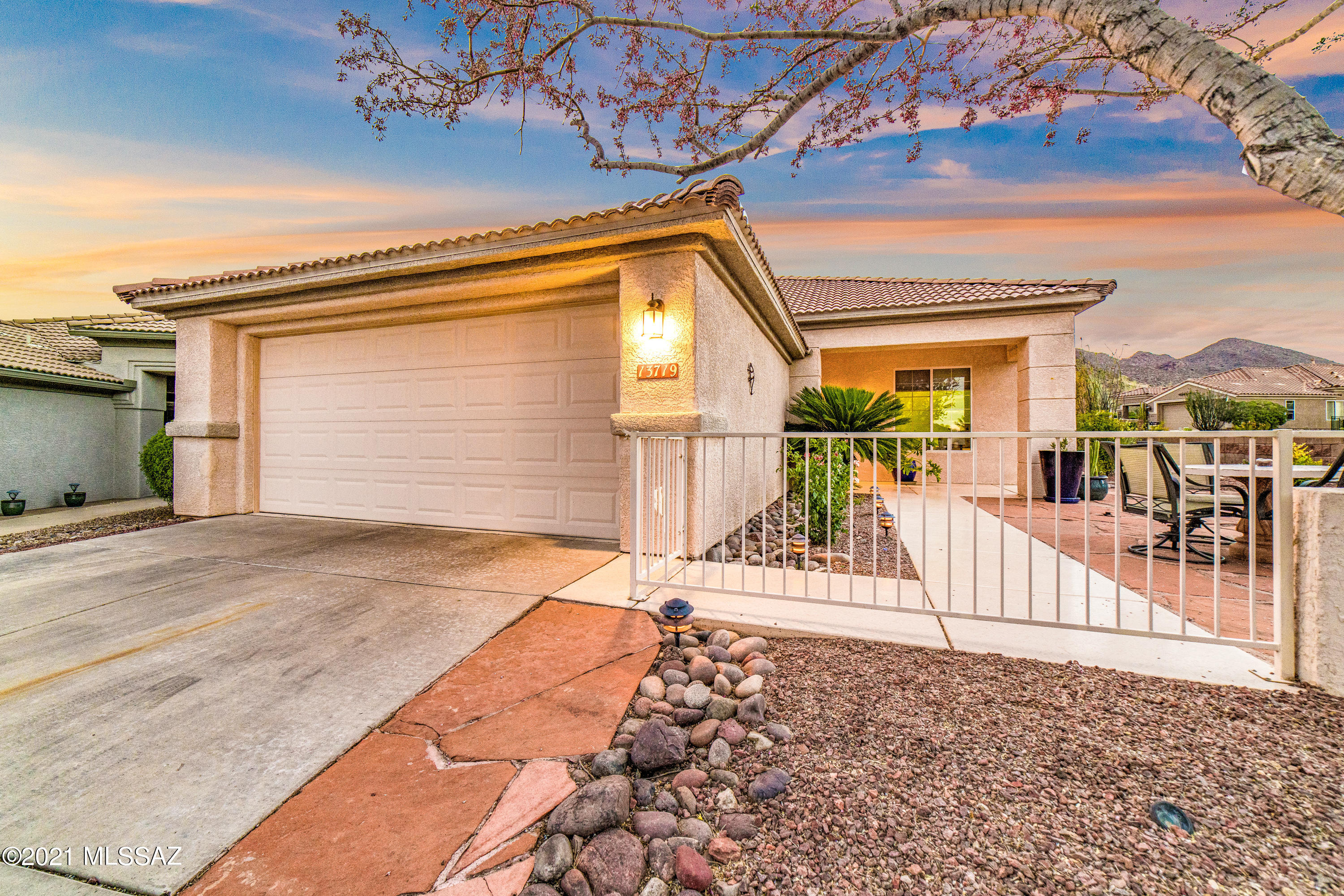 Charming Durango on a ¼ acre corner lot in The Highlands at Dove Mountain! Lush multi-level backyard features mature landscape of large trees, flowering bushes and saguaros. The putting green, water feature, extended patio with concrete pavers, mountain views and an endless pool/spa make this an entertainer's paradise! Spacious flagstone courtyard in front for enjoying your morning coffee. Spanish touches add character and warmth. Large windows and a wide foyer make this home so inviting. Ceramic tile throughout. Large master bath with 2 walk-in closets and dual sinks. Wonderful active adult community featuring golf, tennis, pickleball, pool and spa, fitness center, restaurant, pro shop, event center and more.