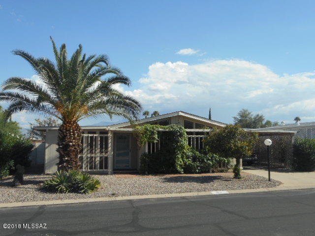 Spacious Unique Home, priced to sell in its present condition. Good bones but needs some cosmetic TLC. Dry wall interior, rounded corners & vaulted ceilings. Great room/dining area concept with open kitchen floor plan, lots of cabinets, pantry, an arch design open pass through to the Arizona Room and patio area for entertainment convenience. Great room also opens on to the finished Arizona room. Slider entry to glassed in enclosed porch from Arizona room and Master Bedroom overlooking private walled in courtyard. Large room off patio that was used for a studio/craft area can also be used as an office. Well sized workshop. New A/C 2017. Under termite warranty with Terminix. HOA $55.00 mo. includes recreational facilities with heated pool and hot tub, library, ceramic, billiards, exercise, rooms, shuffleboard, horseshoes and bean bag toss, card games, bingo and trash pick up once a week.