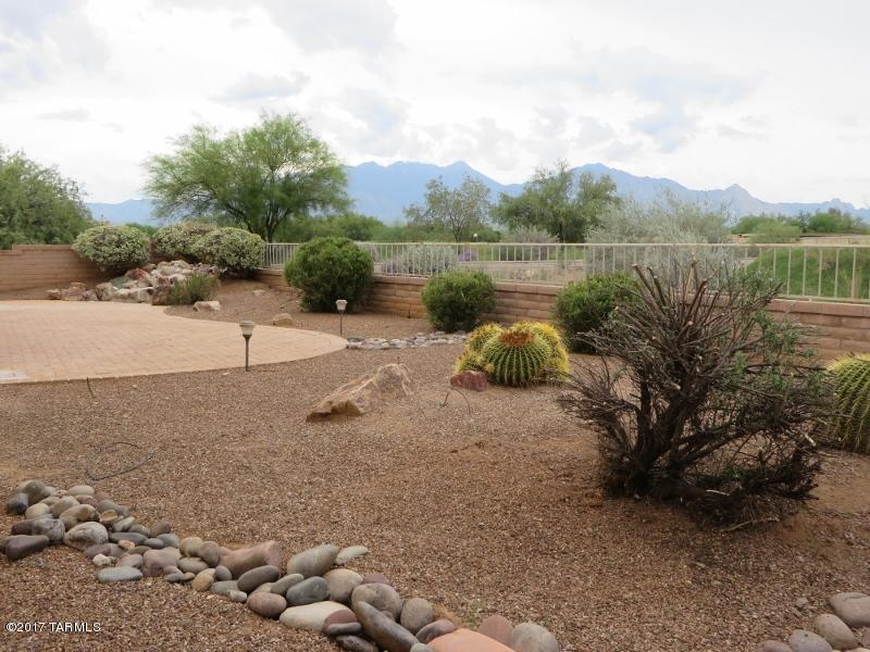 Located on Torres Blancas golf course with great Mt views. Beautiful Phoenician floorplan nicely remodeled!  Relax & enjoy in this like new home offering large great room with fireplace & lots of windows to enjoy the view. Upgraded with new granite counters, new stainless steel appliances, new interior paint and new tile in master bath. Corner location offers golf course & Mt views right out back & across the street. The floor plan offers spacious room sizes, formal dining rm, the popular spacious kitchen, den, 2 1/2 baths & split floor plan. There's also central vacuum, ceiling fans with lights & inside laundry rm. Out front the entry courtyard welcomes you and outback is a delightfully landscaped yard, covered patio,fountain & those great Mt & golf course views! Plus all GVR has to offer