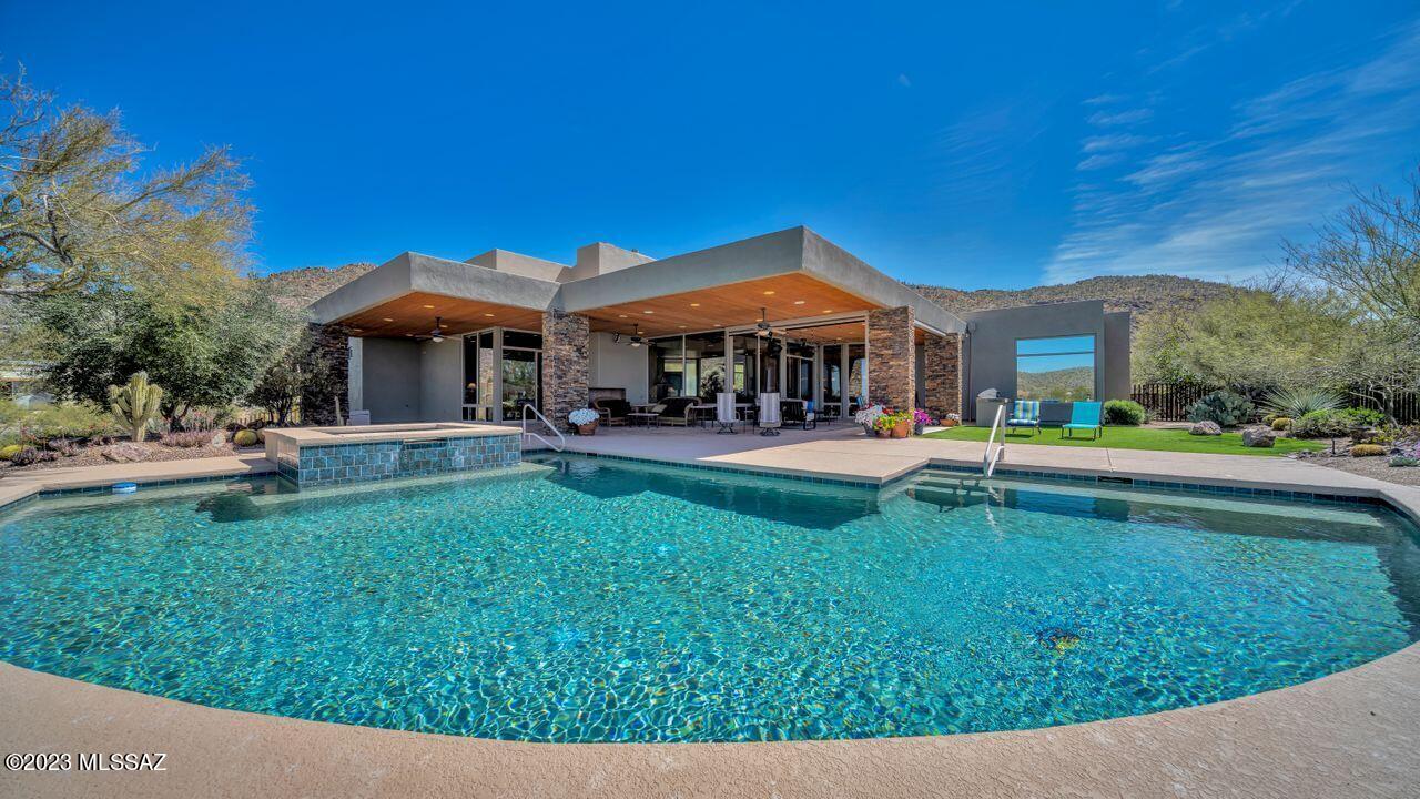 Stunning custom home on the 13th green of the North Course of The Gallery at Dove Mountain. Windows take advantage of the incredible views. This entertainer's delight offers great room, dining room, kitchen w/nook area & bkft bar. Spacious kitchen featuring Dacor 6 burner gas range, Sub Zero fridge, wine fridge, ice maker, prep sink, walk in pantry! Double door entry leads to serene owner's suite w/patio access, jetted tub, huge shower, custom closet. BR 2 has en suite bath, patio/pool access. BR 3 w/ corner windows. BR 4 is currently an office.  The extended patio offers a room of it's own w/ electric screens & heaters, Sparkling pool, spa, water feature all looking down on the stunning golf course  w/ city lights, dynamic sunsets & mountain views. 3 car garage. Call for private showing !