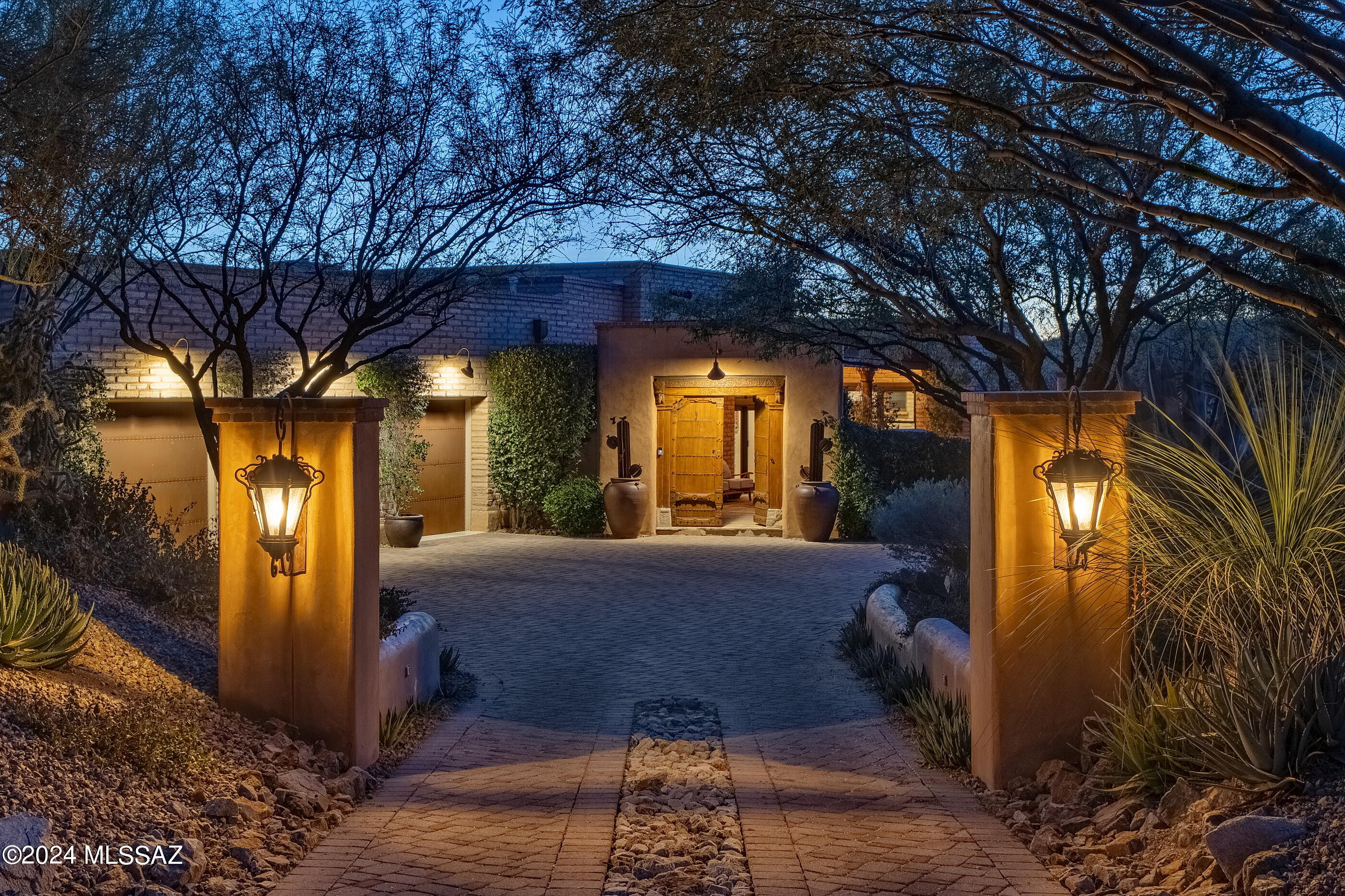 Located in the highly sought after community of The Estates at Honeybee Ridge. Set high on a premium view lot, this home is nestled within the lush natural desert landscape,  adding to the secluded feel of this estate property. An elongated veranda connects the shared living spaces, with a series of glass doors coordinated to tie the interior rooms to the spacious outdoor living environments, resulting in a perfect juxtaposition of private and social spaces.Layers of covered patios are perfectly situated to enjoy year round, with views stretching out over Pusch Ridge and the Catalina Mountains beyond. Native vegetation provides a seamless background to the manicured grounds causing an explosion of color, light, and shadow. Upon entry, you are greeted by a large Great Room with soaring ceiling heights acting as the central hall, inclusive of the formal living room to one side and dining, kitchen on the other, establishing the main connection point of the home. The private East wing of the residence features the sumptuously appointed owner's suite, with custom dressing closet and a luxuriously finished bath, including a large walk-in shower and soaking tub.

The floor plan comprises both formal and informal living spaces, equally suited for grand entertaining, as well as quiet moments, with a chef's kitchen where every measurement and detail has been carefully considered, boasting an oversized custom center island, designed to appear as furniture, complete with top-end fit and finish, including a La Cornue Grand Palais 180 range. Almost 6 feet in length, this handcrafted detail of absolute perfection is the crown jewel of the La Cornue | Château Series, commanding respect and admiration in any kitchen.

This private lot offers a series of patios and exterior living spaces designed for outdoor entertainment. The Southeast facing covered patio offers an outdoor kitchen, complete with a barbecue station, gas cooktop and sink with endless counter space and bar top. The veranda incorporates a masonry fireplace and covered dining patio, perfectly designed to the home's effortless blend of laissez-faire.

A succession of courtyards results in varied focal points, unwinding like a garden narrative of texture, light and mood. Every comfort considered and detail meticulously crafted, results in a home that offers a sense of easiness to enjoy both lifestyle and entertainment.

About the Area:

Honeybee is rich in Arizona History. The canyon that borders the west side of the development is called Honeybee Canyon. According to archeologists that have studied the area, the Native American Hohokam Indians discovered this area and were using Honeybee Canyon from the earliest of times.

Honeybee Ridge is a unique development consisting of 128 Custom Home Sites. The development is smaller than most of its competitors. No resorts, no high-density development, no golf courses, just a nice, quiet, peaceful place to enjoy Arizona living.

The Estates at Honeybee Ridge encourages its residents to be creative with high-quality materials and designs that are conducive to our wonderful landscape. When the development is complete, 128 custom homes will be built, all homes will be single-story, lot sizes are a minimum of one acre and design guidelines limiting disturbance to 16,000 feet per lot (not including driveway) will keep 75% of the development pristine & untouched.