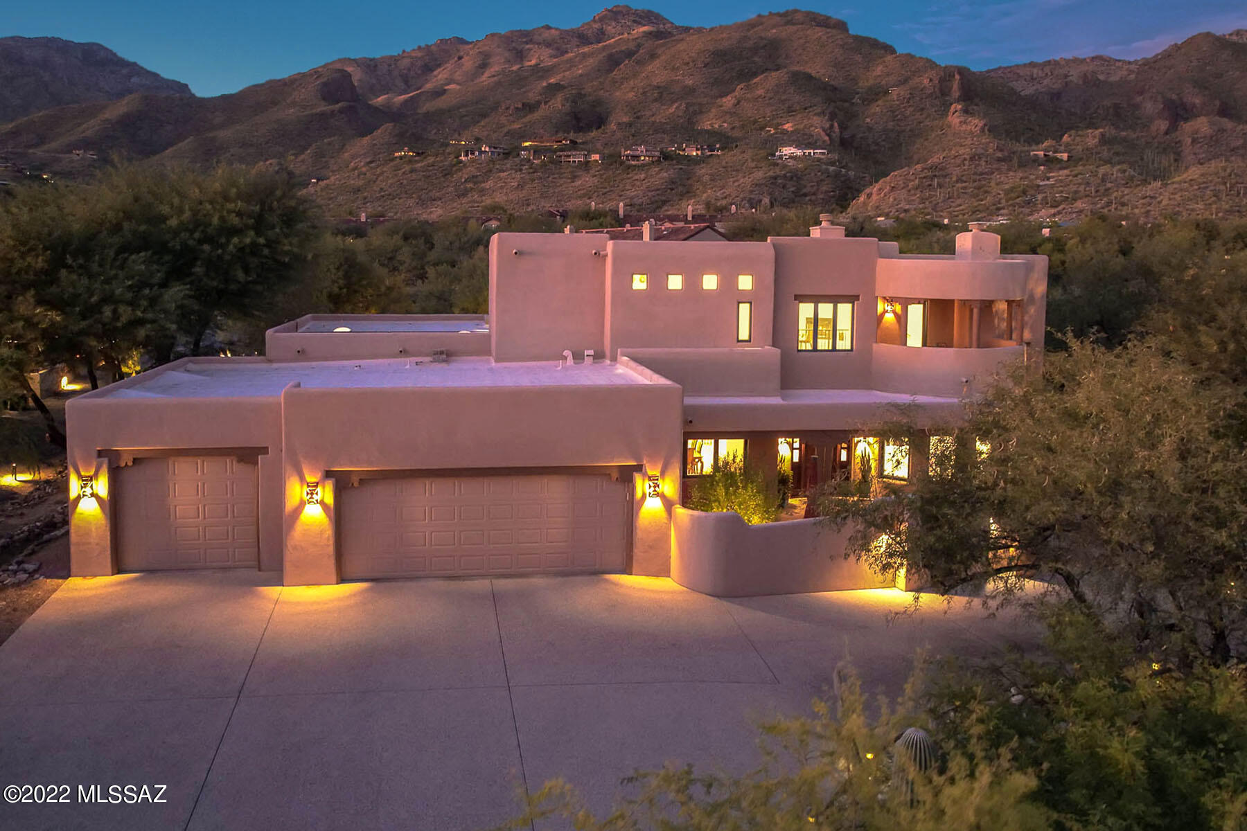 Seldom does a home come on the market that exemplifies the unique blend of modern design w/the true essence of Santa Fe. This recently updated 3830 sq.ft. 4 bed/3 bath home w/all new Sierra Pacific windows/sliders enjoys panoramic  mountain & city views from multiple private balconies.  Enter this all masonry constructed home through charming courtyard leading to mesquite entry door to grand foyer showcasing hand forged wrought iron chandelier.  Cozy corner beehive FP in Kiva room creates true Santa Fe ambiance.  The kitchen is the heart of the home  featuring Sub-Zero Refrige,  Wolf gas cooktop, Dacor ovens & Taj Majal Quartzite counters.  Barn door separates  den w/beehive FP from primary suite w/private balcony.  Entertain in serene, private backyard w/lush vegetation & oversized pool.