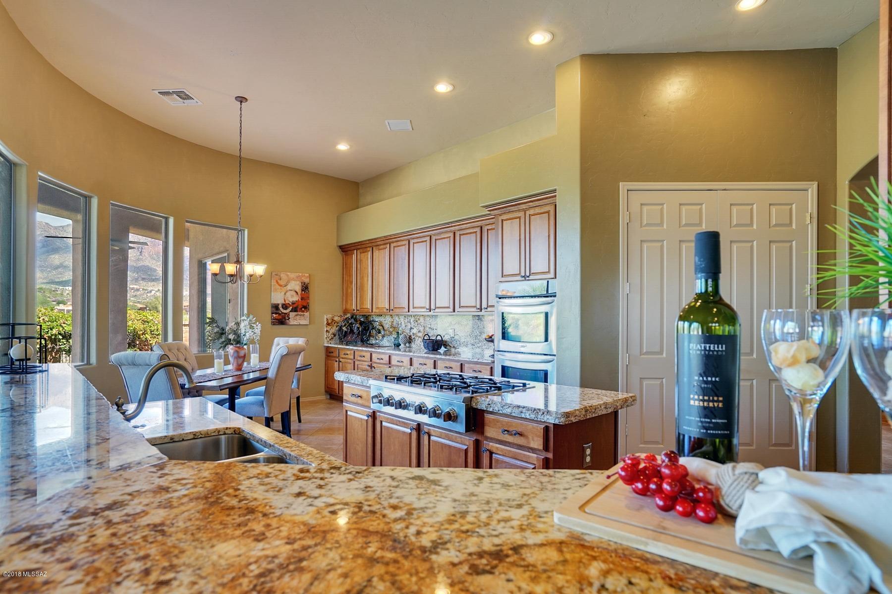 Awe-inspiring Catalina Mountain and La Paloma golf course views and resort style living! This home has it all.  From your first step inside the front door you will notice the spacious rooms and generous, open floor plan.  Private master-suite on the main floor has access to the outdoor patio and pool. Expansive kitchen has granite counters and incredible amounts of storage.  Separate living room and great room off the outdoor patio allow for seamless entertaining. Second story bedrooms also have their own loft/game room. Backyard has views for days along with an outdoor kitchen and pool/spa with rock slide. Don't be dissuaded by the address, this home sits off Pontatoc between Sunrise and Skyline and traffic is minimal North of Sunrise. Take a look, you will not be disappointed you did.