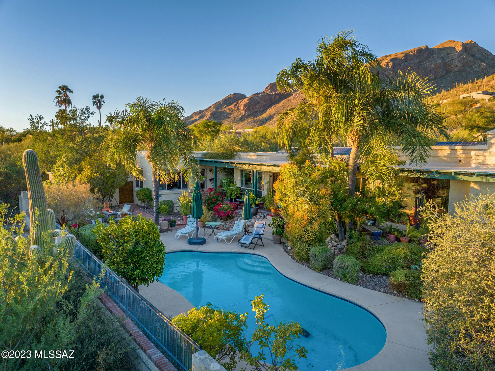 Beautiful foothills home nestled high in prestigious gated Sin Vacas boasts stunning mountain and sunset views. This elegant 4bd/3ba main home has been lovingly upgraded by its owners and includes updated 1bd/1ba casita with kitchen. The remodeled kitchen in the main house is a cook's dream with granite countertops, Wolf appliances, wine fridge, cherry cabinets, opening into the dining room. The master suite includes a remodeled luxury bathroom with freestanding volcanic limestone bathtub and attached outdoor shower and atrium. Casita has full kitchen with Corian countertops, Wolf induction cooktop and washer/dryer. Private and lush backyard with fully refurbished pool and spa, and mature plants that have been meticulously maintained make this an entertainer's dream! See supplement Solar is TEP owned and has a guaranteed monthly charge. Solid hard core doors throughout. This highly desirable neighborhood is a serene desert retreat.  See seller upgrades list in documents.
