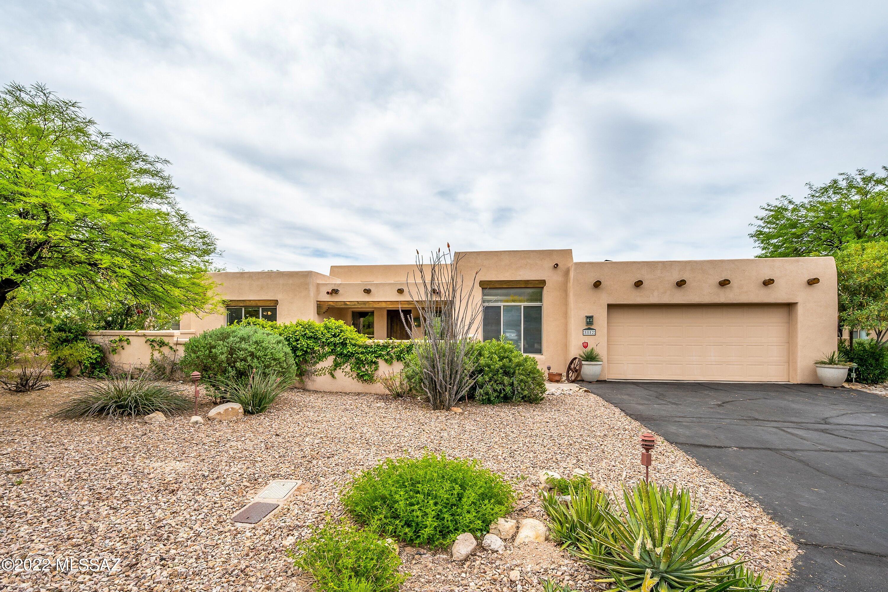 SPACIOUS CUSTOM HOME in GATED enclave in Northeast Tucson. Lush, private courtyard greets you upon entering this 4 bed/4 full bath home w/ a SUITE at EACH END. Lovely backyard with sparkling pool, hot tub & fireplace on the massive covered back patio. Chef's kitchen equipped w/ gas range, granite counters, 2 large pantries & plenty of cabinets w/ tall uppers. Clean, bright & open great room plan features soaring ceilings, skylights & expansive windows. PRIVATE GUEST SUITE includes a large bedroom, accessible bathroom & BONUS room w/ direct access to pool & patio. Enjoy low-cost electric w/ the leased solar system. Oversized 2 car garage provides lots of extra space for hobbies, crafts & storage. Shopping, golf, restaurants, Mount Lemmon, schools & library nearby.