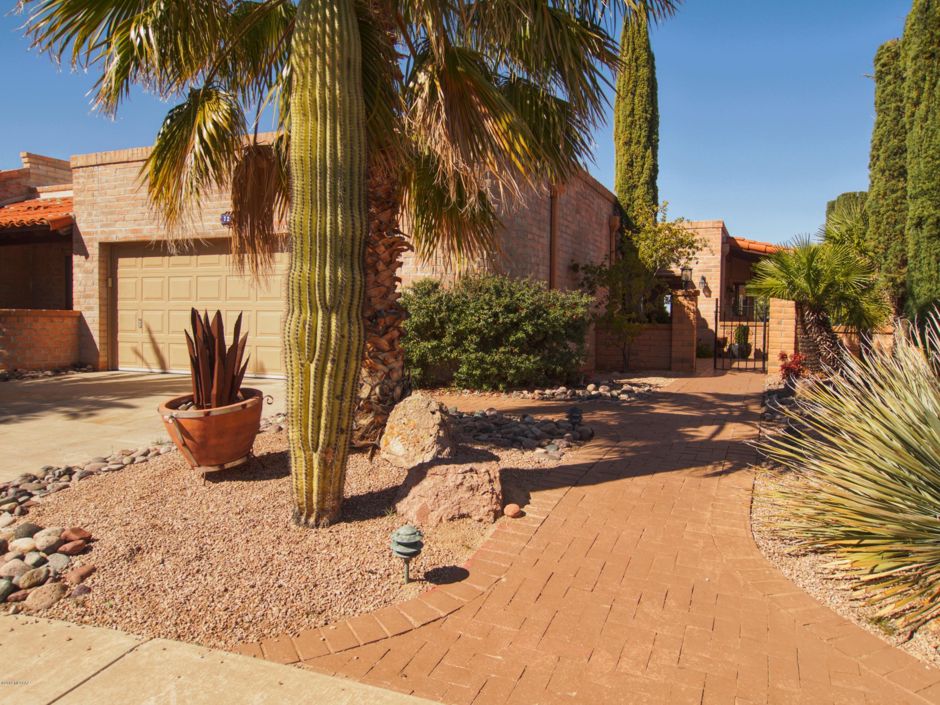 You'll love this Beautiful Townhouse in the desirable neighborhood of Desert Ridge. Gorgeous Mountain, Water Ponds and Golf Course Views. Great location on cul-de-sac with little traffic. Solid built slump block exterior with large wrap-around covered patio, ideal for friends and family gatherings as well as your own private park like retreat. Authentic saltillo tile throughout the entire house, designer painted interior walls, the 14 skylights always provide bright and cheery natural light indoors. The custom built entertainment center and buffet are a focal point and unique to the home. Light maple kitchen cabinets with plenty of pull-outs, corian counters and stainless appliances. Master bath includes a gorgeous glass block shower. Low maintenance landscape. HVAC replaced 2007.