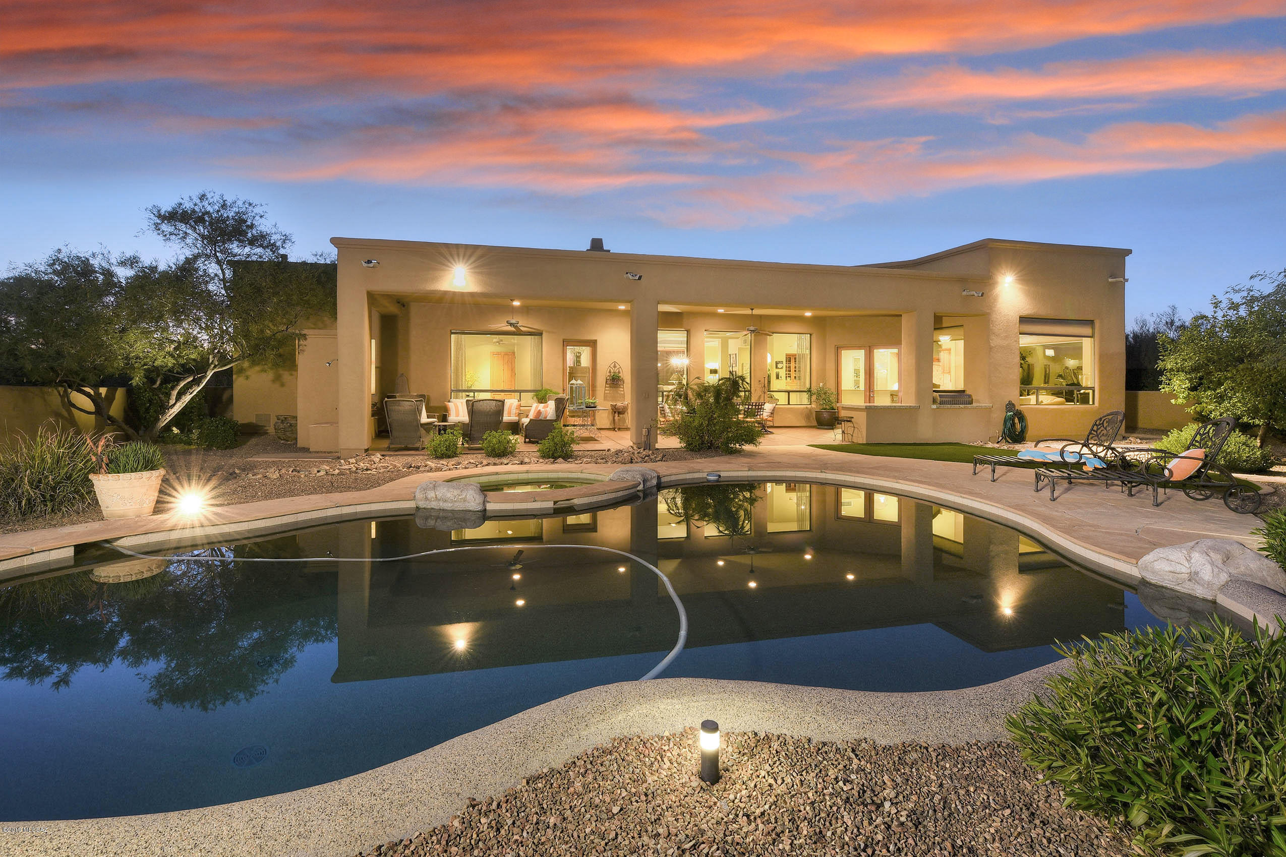 *DESERT ELEGANCE*  ENCHANTING HOME IN ORO VALLEY FILLED W/CHARM & CUSTOM DECOR! HIDDEN TREASURE IS PERCHED ON PREM .84 AC HOMESITE! POPULAR EAST FACING EXPOSURE BORDERS NATURAL DESERT...PANORAMIC'' PUSCH RIDGE'' MTN VIEWS EMBRACE YOUR ENTIRE HM! HEAVENLY BKYD- ENJOY ALFRESCO COOKING-BUILT IN BBQ/GRANITE CTR, COV'D PATIO- COZY WOOD BURNING FP, SPARKLING PEBBLE TEC POOL/SPA, GRASS,MATURE TREES & KIDDIE PROOF FENCE! ORIGINIAL OWNERS- HAVE TASTEFULLY DECORATED & CARED FOR THIS HOME! UPGRADES GALORE- GREAT RM, WALLS OF WINDOWS, STONE/WOOD FLOORS, 8 FT WOOD DRS, CHERRY CABINETRY, GRANITE SLABS, DACOR /SUB ZERO/ASKO APPLIC, OVERSIZED ISLAND, POT FILLER, COURTYARD ENTRY, MASTER SPA BATH W/FREE STANDING TUB- HUGE SHOWER, ALL CUSTOM WINDOW TREATMENTS , EXPANDED ''3 CAR ''GAR W/SEP STORAGE! TRUE GEM!