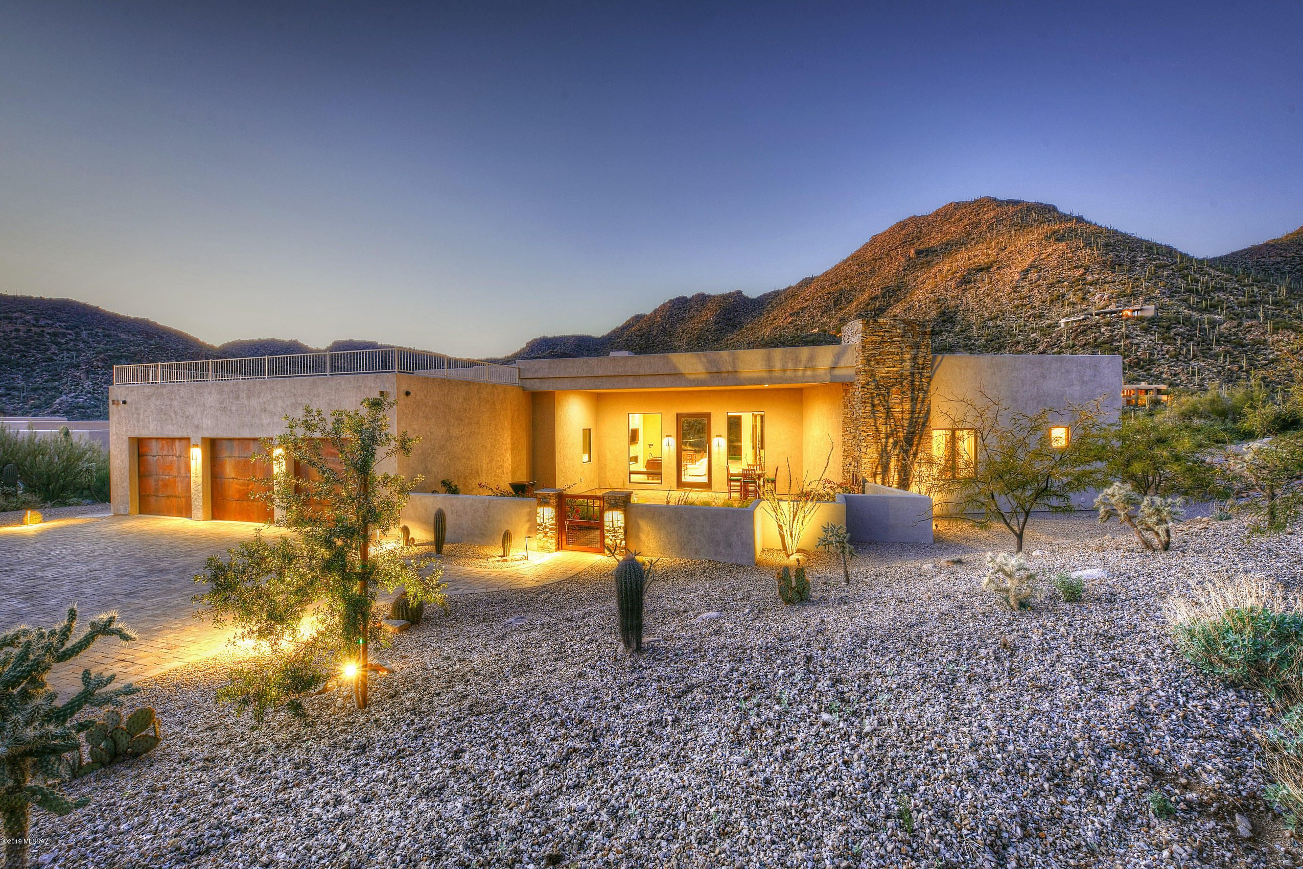 Nestled against the Tortolita Mountains in the guard gated community of Canyon Pass, this 4Bd/4,133sqft custom home affords panoramic Canyon/Mountain views throughout. This luxury home features a spectacular Great room for modern living with rock ledge fireplace & fully retractable sliding glass doors. Open concept chef's kitchen with professional grade appliances, stunning granite counter-tops, island w/prep sink, wine fridge & walk-in pantry. The elegant Master suite hosts a fireplace, luxury bath, plus room size closet. Gorgeous tile and wood floors throughout. All bedrooms feature en suite baths. 550-bottle wine cellar. Fabulous outdoor living incorporates a gated front courtyard, heated saltwater pool & spa, fire pit, and rooftop terrace affording spectacular Canyon & sunset views.