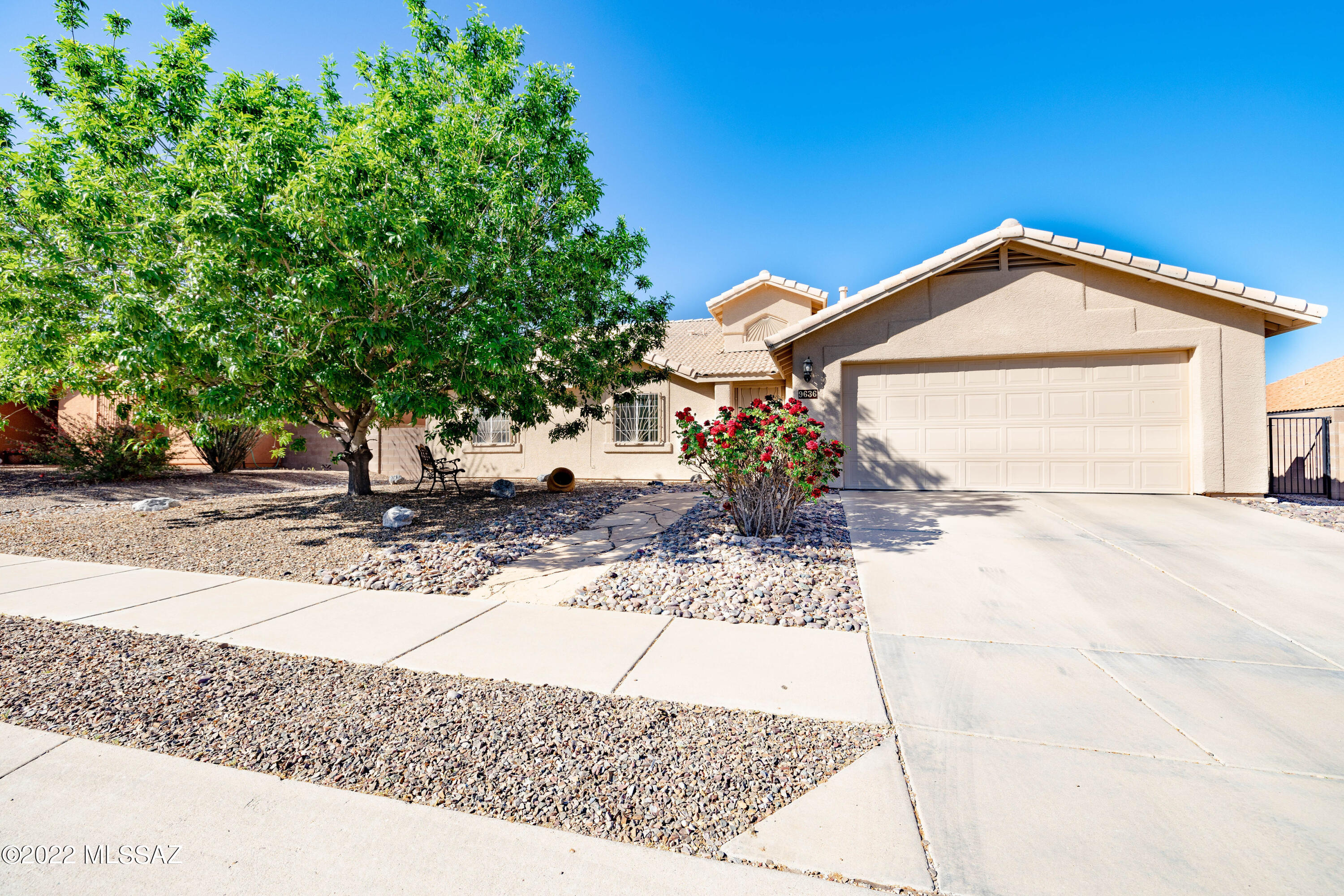 Beautifully maintained 4 bed, 2 bath single story in Rita Ranch! Neutral paint and tile throughout- NO carpet! Ample counter/cabinet space with peninsula in kitchen, cozy fireplace in the living room, dual vanities and large closet in master, and updated flooring in the bedrooms. Retreat to the serene backyard with covered patio, artificial turf, and easy low maintenance landscaping. This gem will go quickly- schedule a tour today!