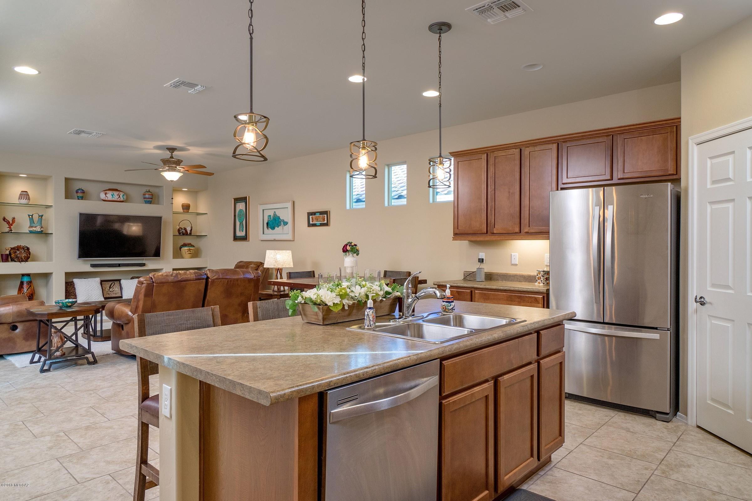 Seller will accept/counter offer btwn $219-$225K. Del Webb 55+ Rancho Del Lago, Spirit Model. 2 bedroom/2 bath and a den. This home has been meticulously maintained and is move in ready. Beautiful tiled floors, Kitchen open to well planned living/dining area. Breakfast bar on island makes for great casual dining and more than enough room for your dining room table and buffet. Plenty of niches for your special decor and great light! The private pavered patio has a fountain that conveys. Split bedroom floor plan. Huge walk in closet in the master bedroom and  additional storage in the oversized laundry room.  Community features pool, spa, tennis and other sports courts, rec center with gym, billiards and more! Great active adult lifestyle at a great price!