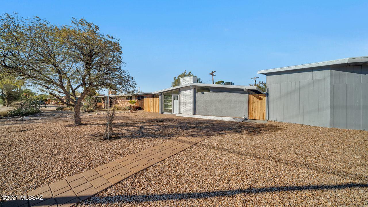 Remodeled 3 bedroom 2 bath home on the East side near Shopping Center and Restaurants. Open floorplan with new kitchen equipped with a large gorgeous island with granite countertops and new stainless steel appliances. Wood burning fireplace in the living room. Owners suite has updated bathroom and fixtures with a private access to yard. New roof in 2020, new water heater, new AC. Bonus room with lots of potential detached from home to use as guest quarters, studio or game room.